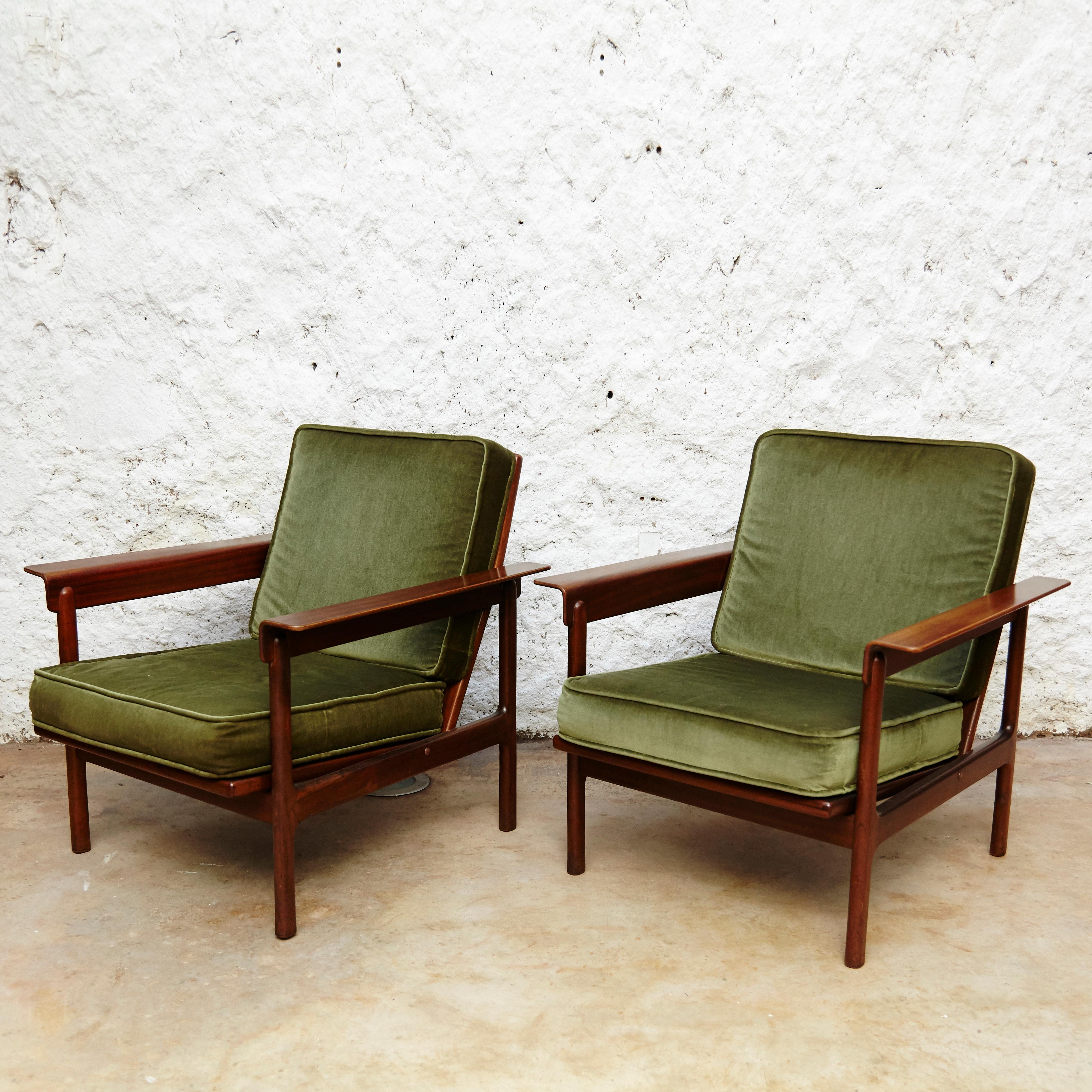 Set of two easy chairs.
Manufactured by AG Barcelona circa 1960.
Made in teak wood with original green upholstery.
Scandinavian style.
Stamped by Manufacturers Label.

In original condition with minor wear consistent of age and use, preserving a