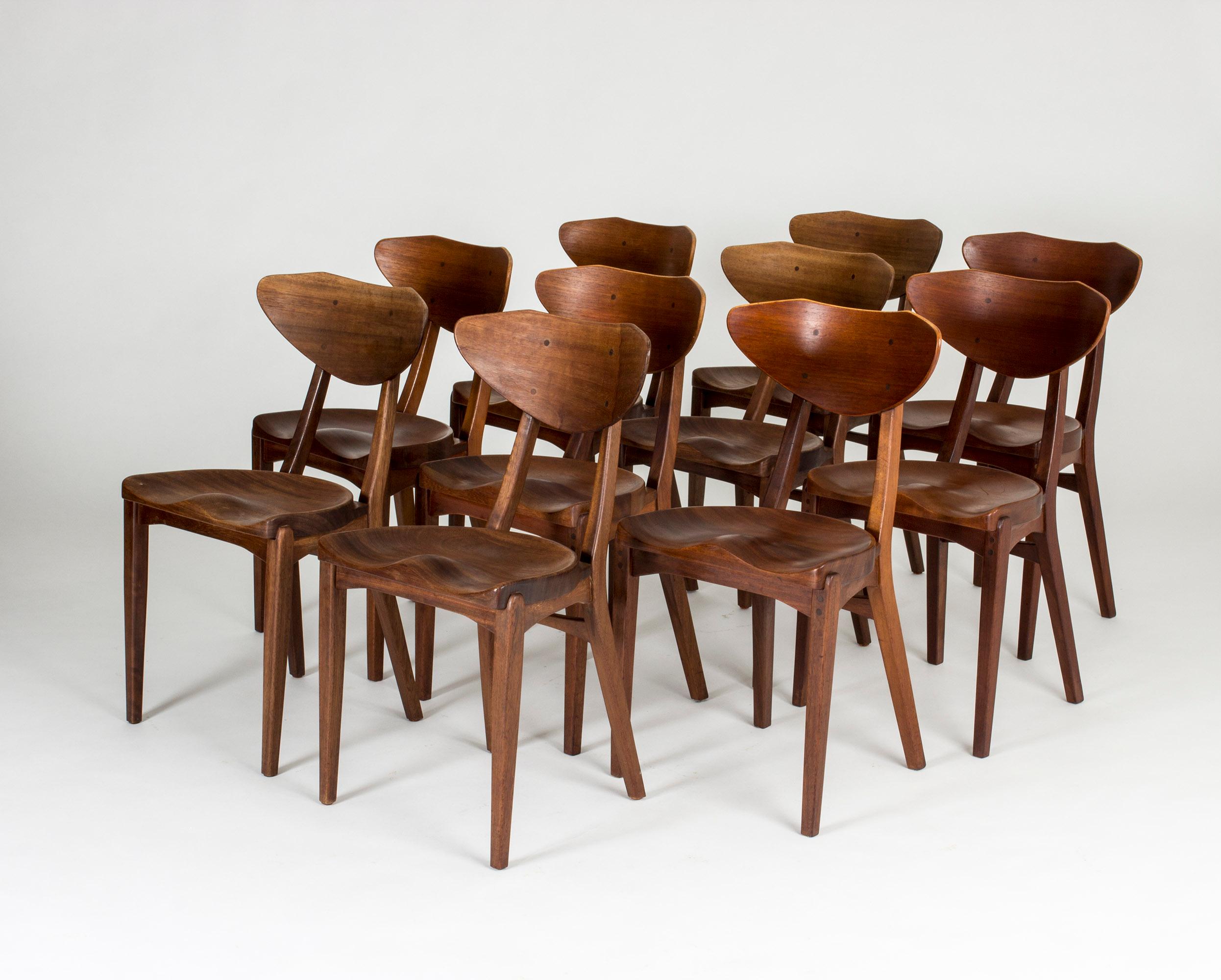 Set of ten stunning dining chairs by Richard Jensen and Kjærulff Rasmussen, made from teak. Solid teak seats inspired by traditional anatomical milk stools. Handles on the back och the backrests.