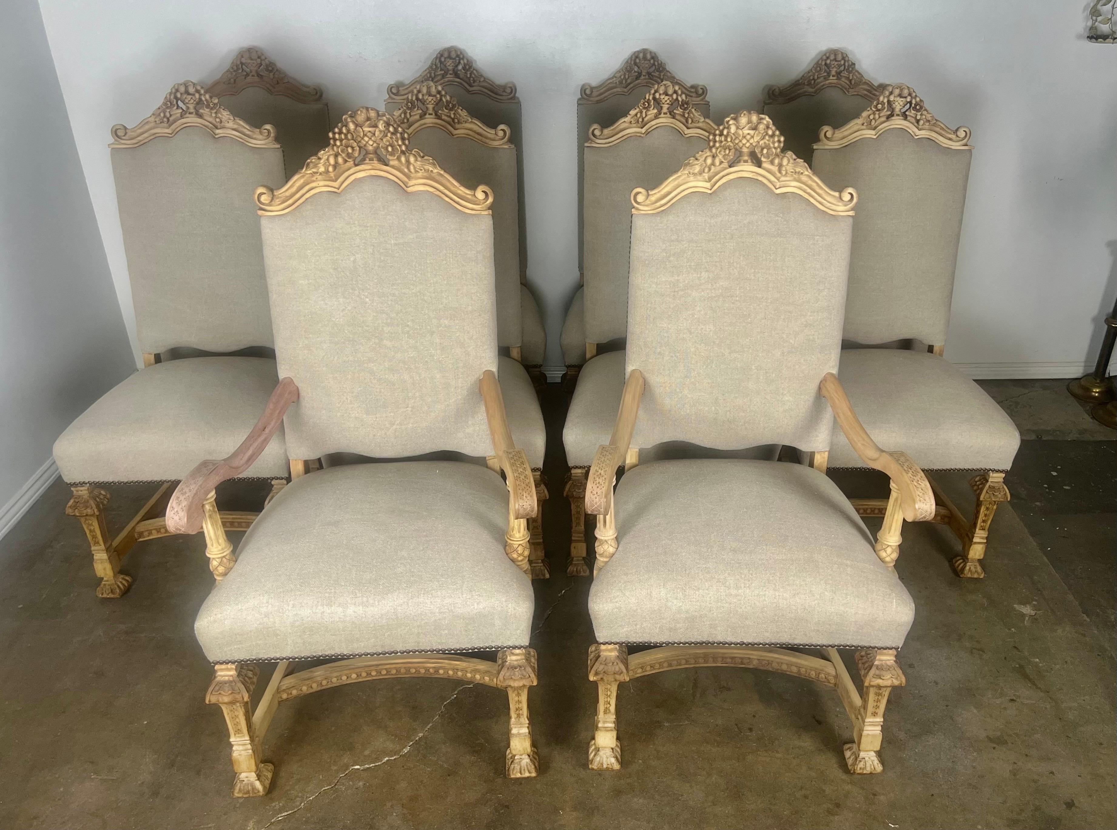 Set of Ten Italian Rococo style dining chairs with hand carved floral urn at tops of chairs.  The urns are flanked by two scrolls.  The chairs stand on four straight legs with intricate detailing throughout.  Newly reupholstered in a washed Belgium
