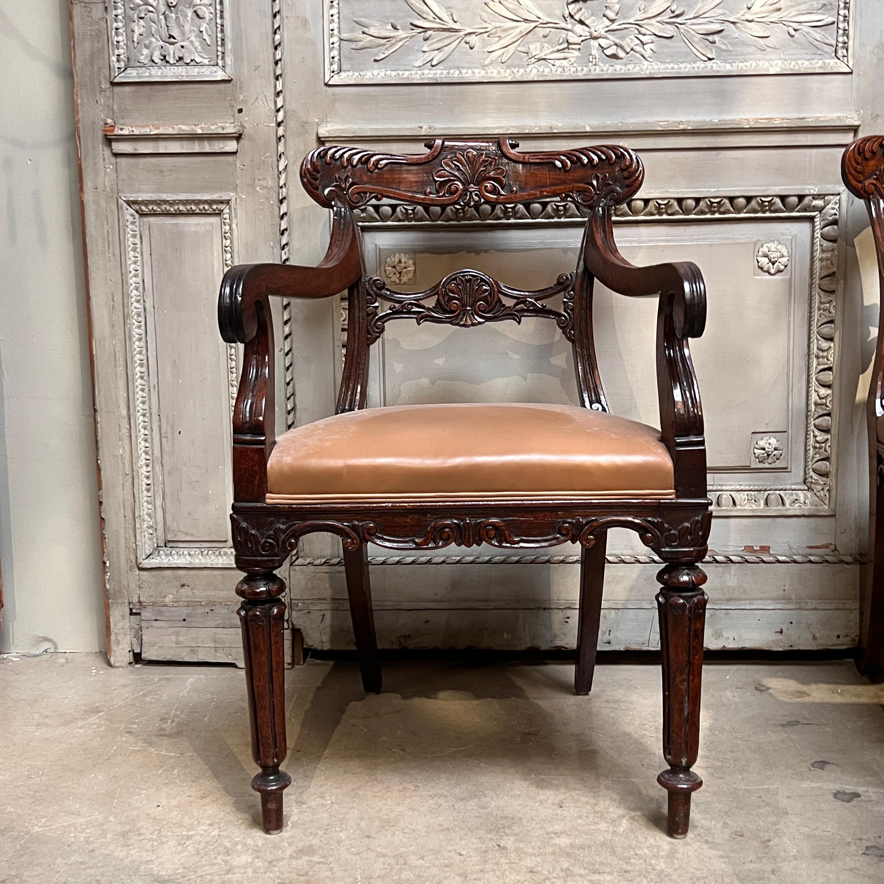 A beautiful set of 19th Century English Dining Armchairs made in solid Padauk with acanthus carved details throughout and raised on reeded front legs.  Strong sturdy chairs with wonderful colour.  Circa 1830.
The chairs are upholstered in a nice
