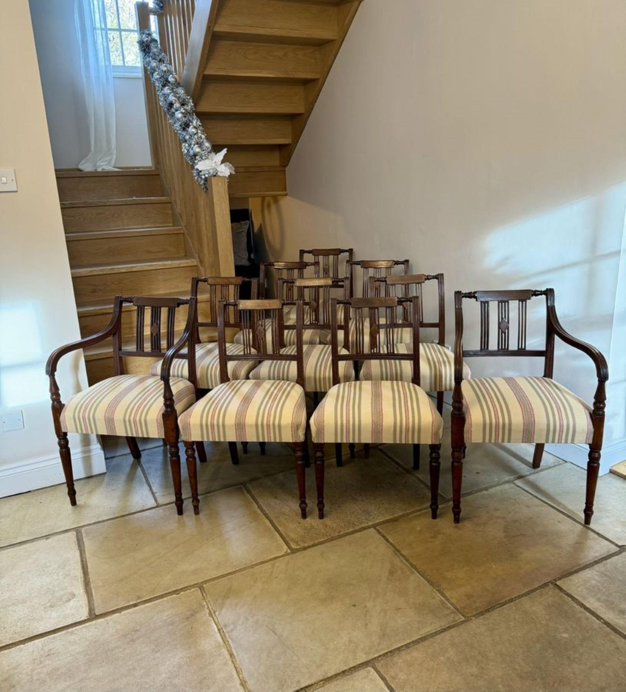 Set of ten antique George III quality mahogany inlaid dining chairs, consisting of two carvers and eight single chairs with an inlaid top rail reeded splats to the centre, the carver chairs have shaped reeded open arms, upholstered seats standing on