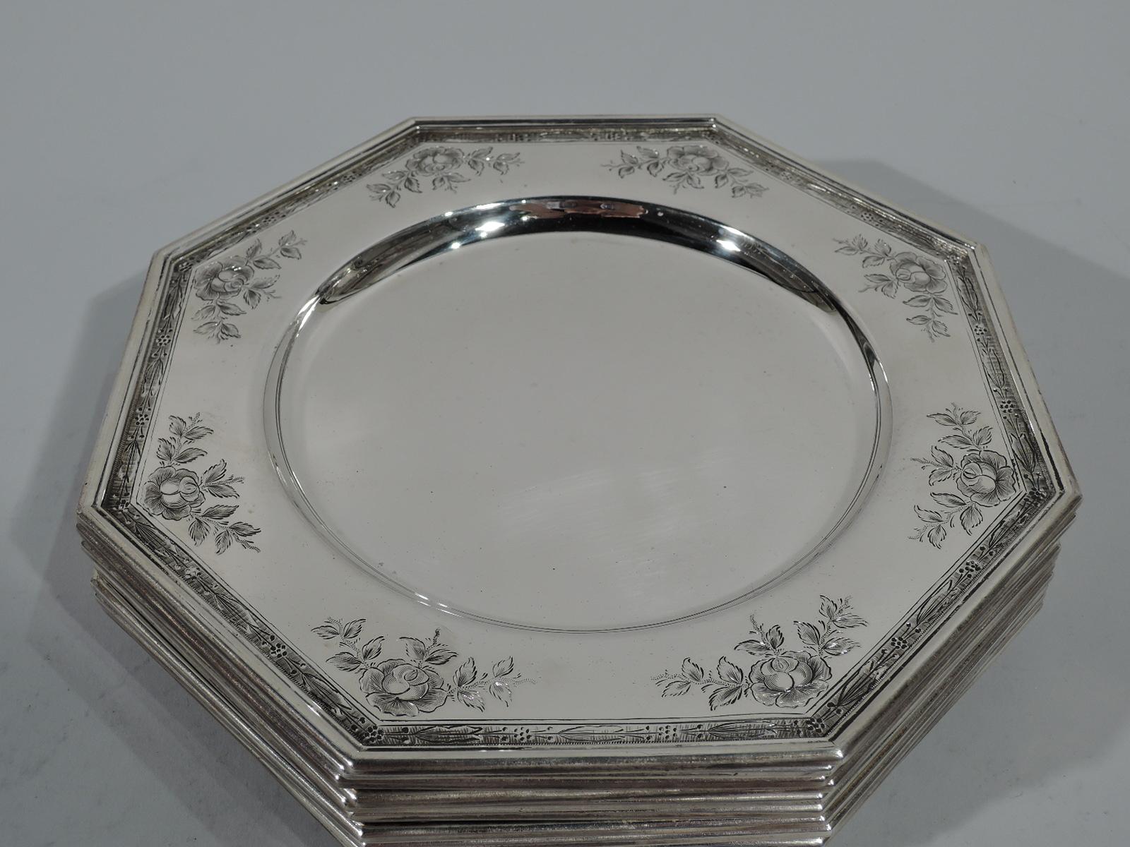 Set of ten Edwardian sterling silver bread-and-butter plates. Made by Gorham in Providence. Octagonal with circular well and molded rim. Engraved roses and stylized floral border on reeded ground. Hallmark includes no. 1361L. Total weight: 89 troy