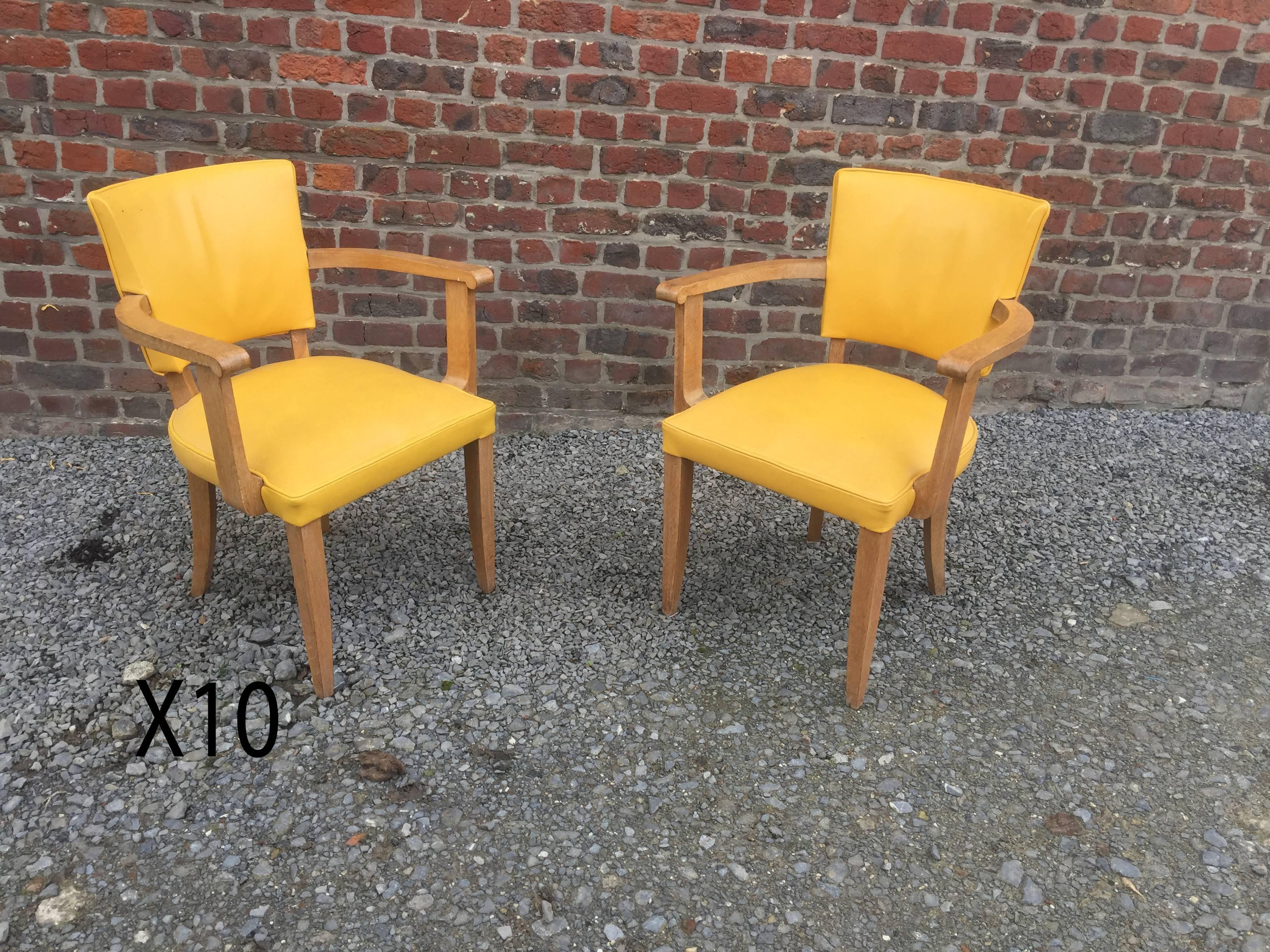 Set of ten Art Deco armchairs in oak and leather, circa 1940.