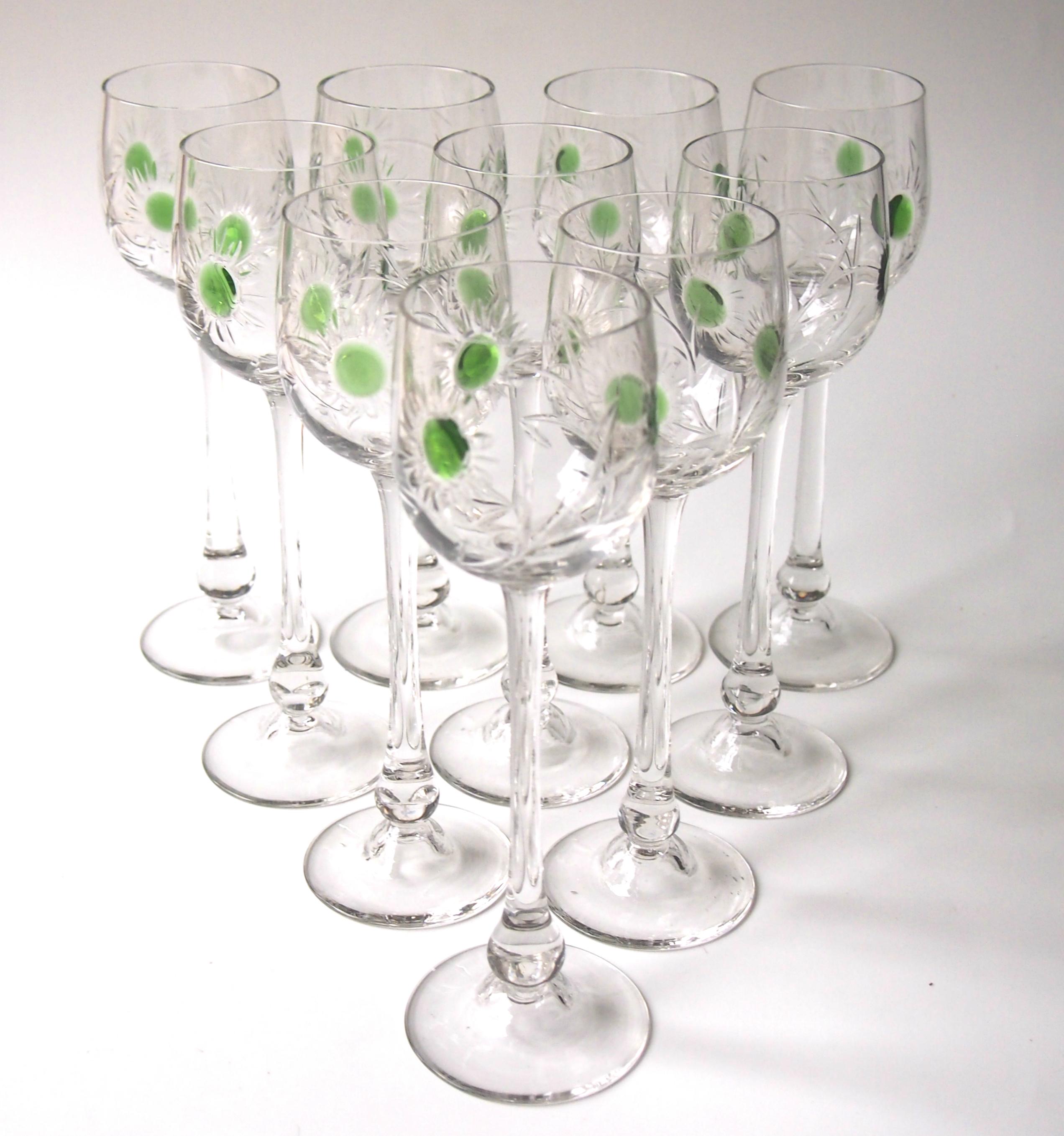 Stunning set of ten Art Nouveau hot applied hand cut crystal hock glasses by the important German maker Jean Beck. Each elegant glass has three hot applied green spots and was then hand cut in a stylised Art Nouveau pattern. One of the most