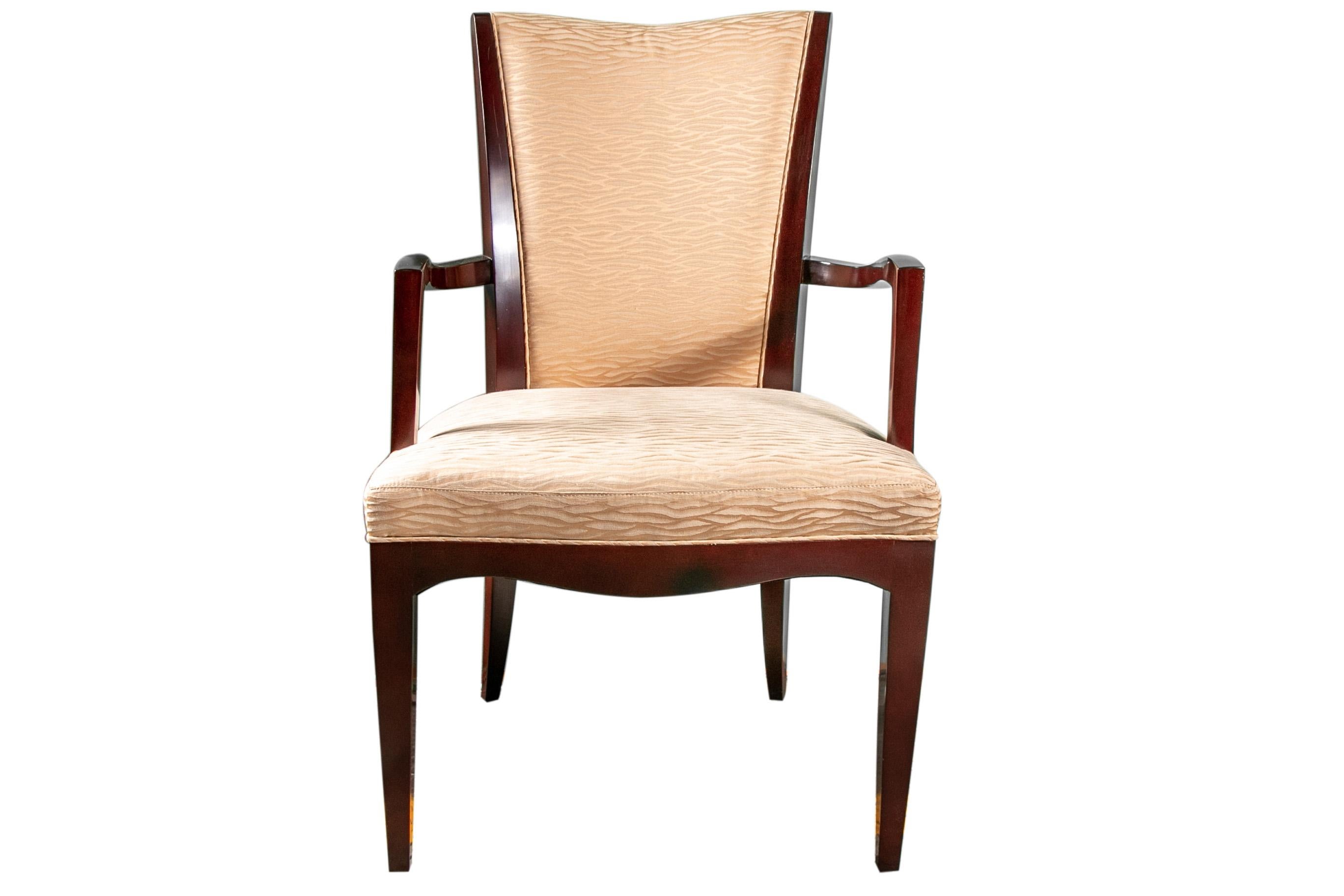 Two-arm and eight side chairs. Fine dark brown glossy stained frames with upholstered seats and back rests in a wavy pale yellow textured fabric. Raised on square tapering legs. Labels underneath.

Condition: One side chair crest rail end chipped,
