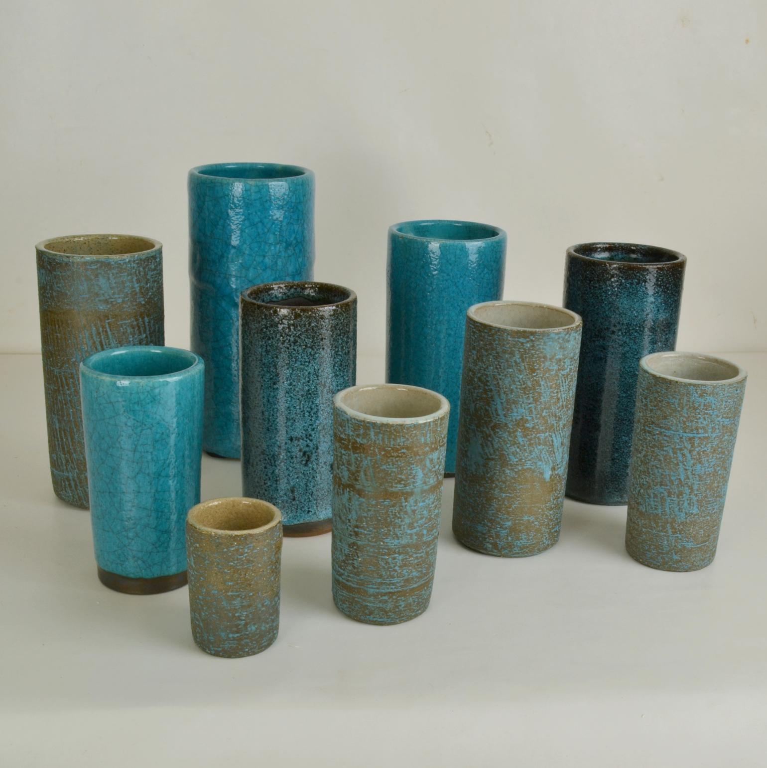 A set of ten studio ceramic cylinder vase of various heights in turquoise tones created in 3 different glazes produced in the 1960's. 
Pieter Groeneveldt ((1889-1982), born in Batavia, the former Dutch Indies. Groeneveldt was a Dutch artist and