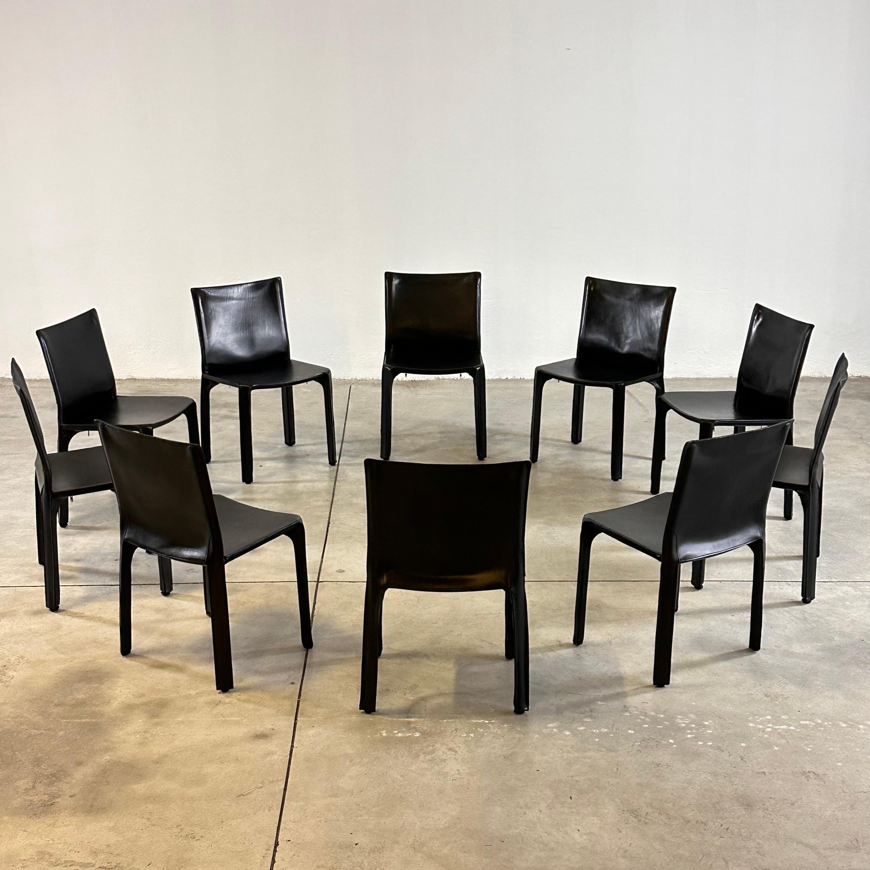 A set of Ten Italian design icons in black saddle leather.

When first produced in 1977, the CAB was the first chair to feature a free-standing leather structure, inspired by how human skin fits over our skeleton. The leather upholstery is