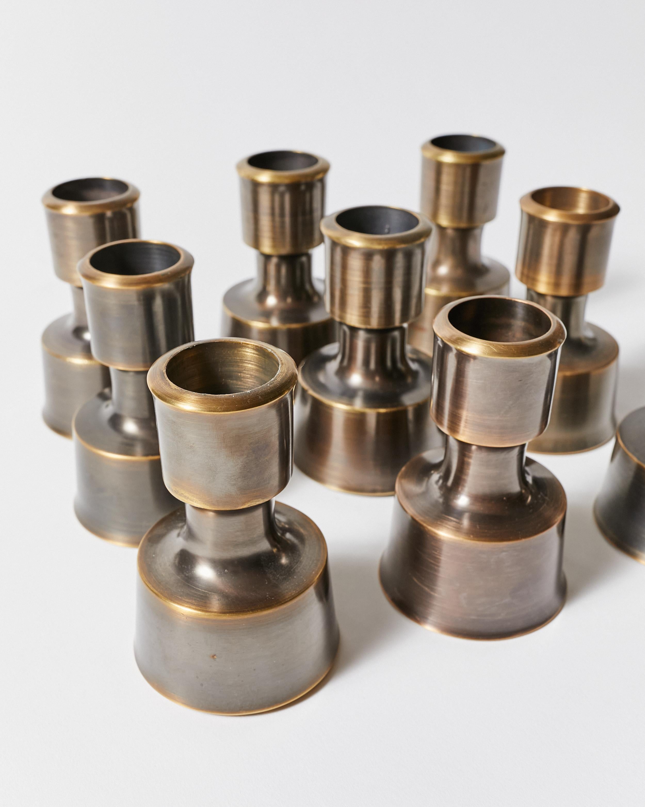 Set of ten vintage candle holders refinished in antique bronze. Designed by Jens Harald Quistgaard for Dansk Designs.