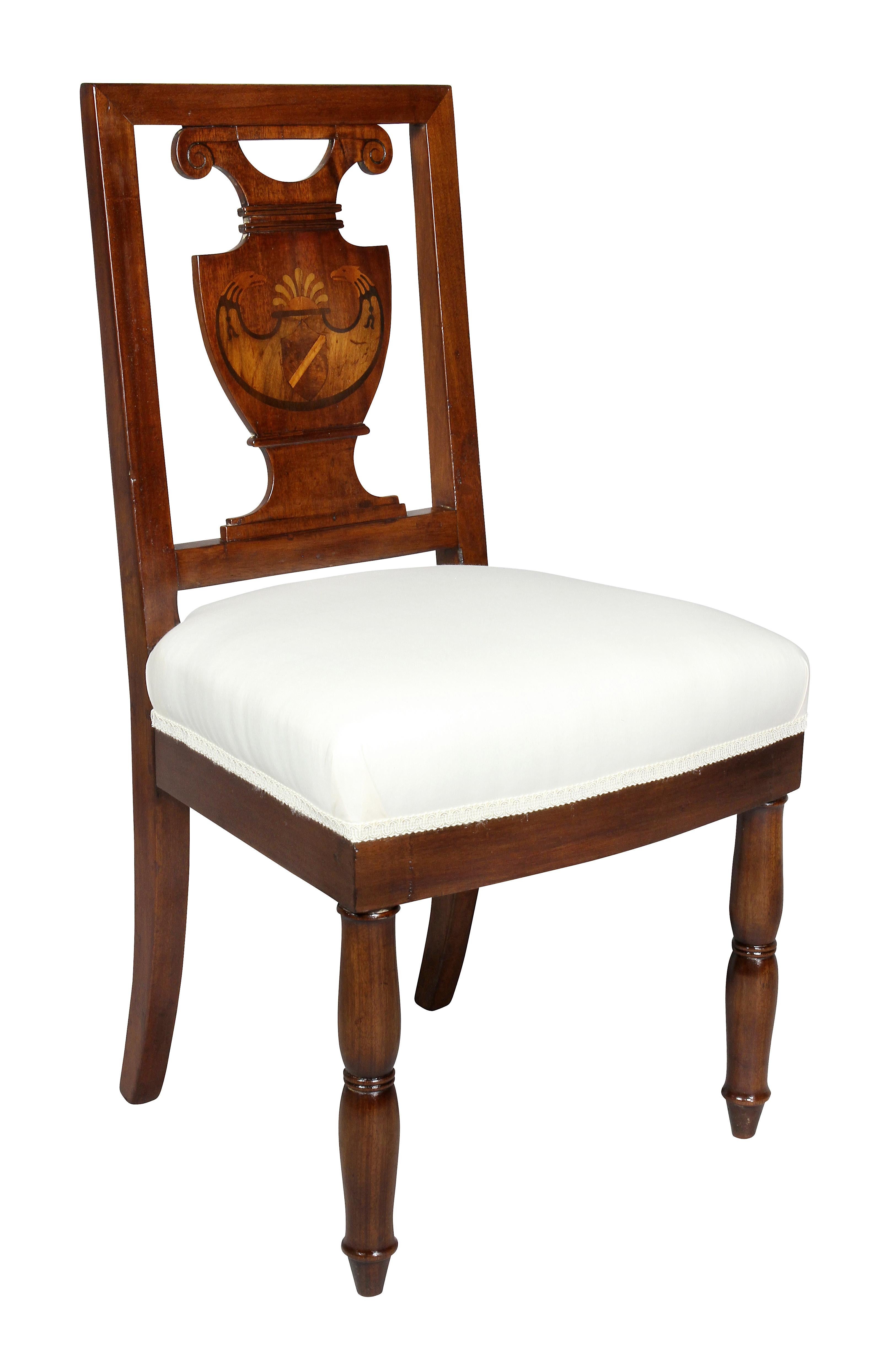 Each with square backs and urn form splat with inlaid shield with double eagle head and rising sun with various woods, completely newly upholstered seats, circular turned legs. Each chair inscribed on seat rail in contemporary of the period script
