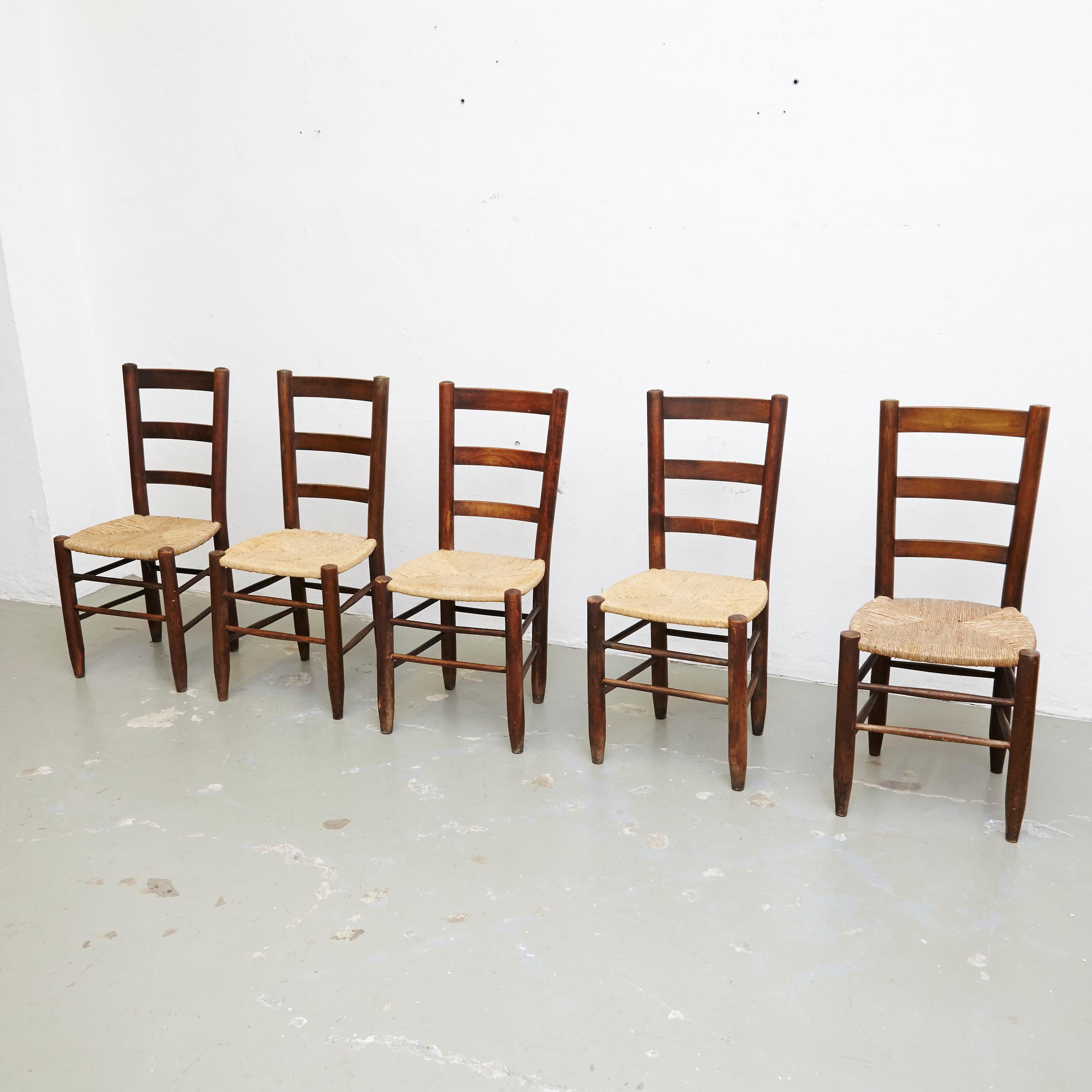 Set of ten dining chairs, model N19, designed by Charlotte Perriand, circa 1950.

Solid wood base and legs, and rush seat.

In original condition, with minor wear consistent with age and use, preserving a beautiful patina. The seats rush has