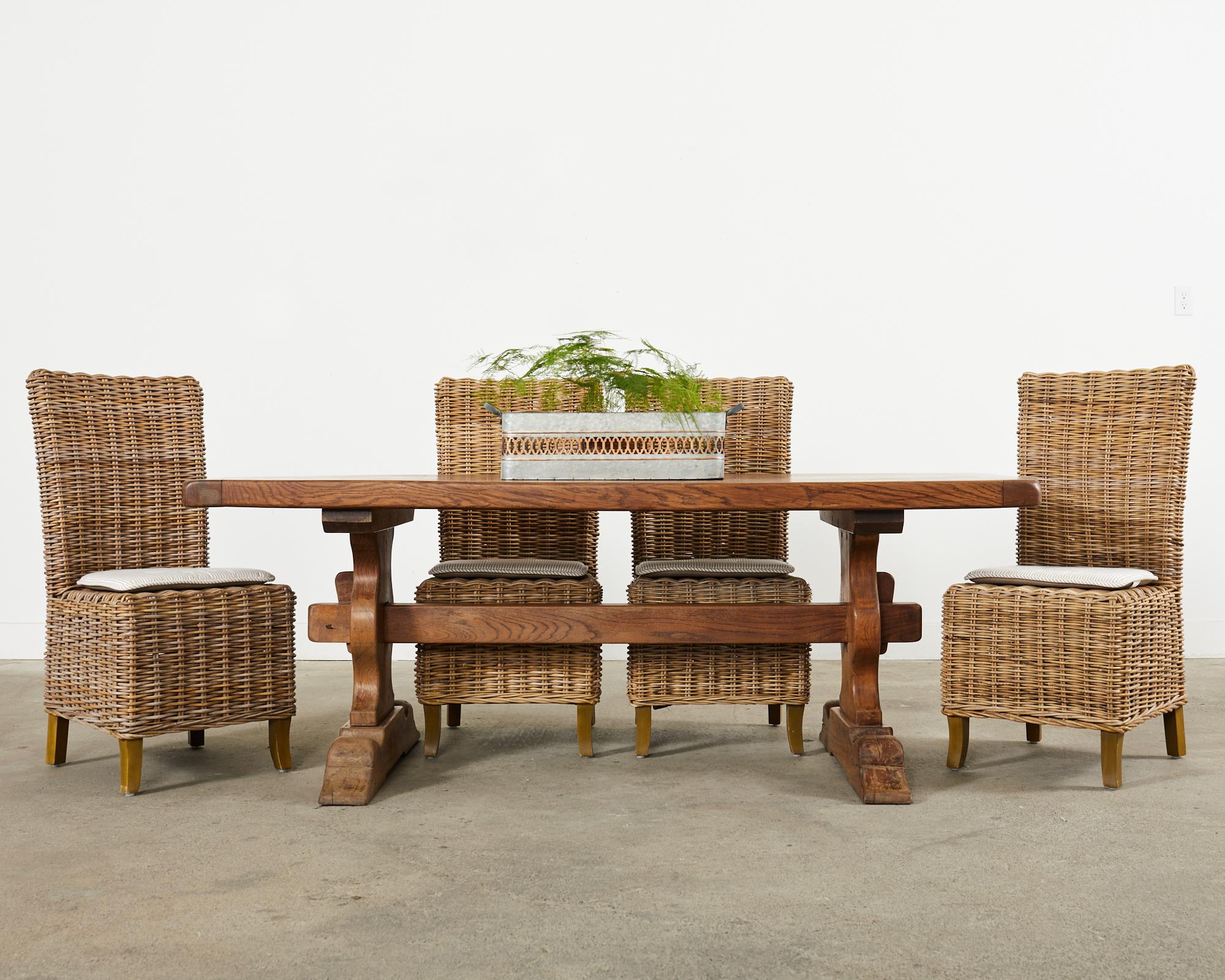 Large set of ten woven rattan wicker dining chairs made in the California coastal organic modern style. The chairs feature wooden frames with a tall square high back in a parsons chair style. The frame is covered with woven rattan wicker or stick