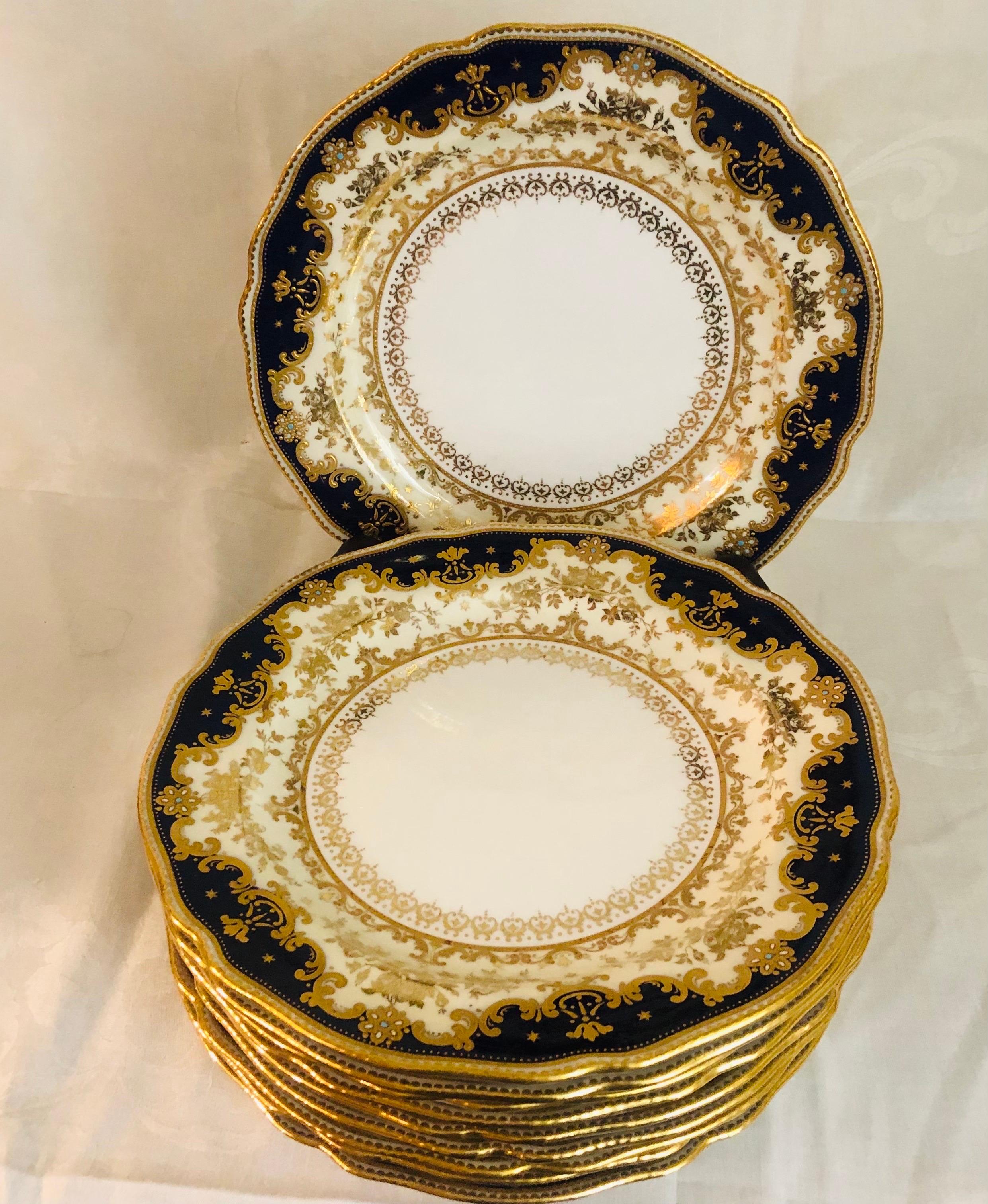This is an absolutely stunning set of ten cobalt dinner plates made of Copeland's jeweled porcelain. Each plate has a cobalt fluted border with raised gold arabesque decoration. Inside this outer border, is a cream border with a gold flowered