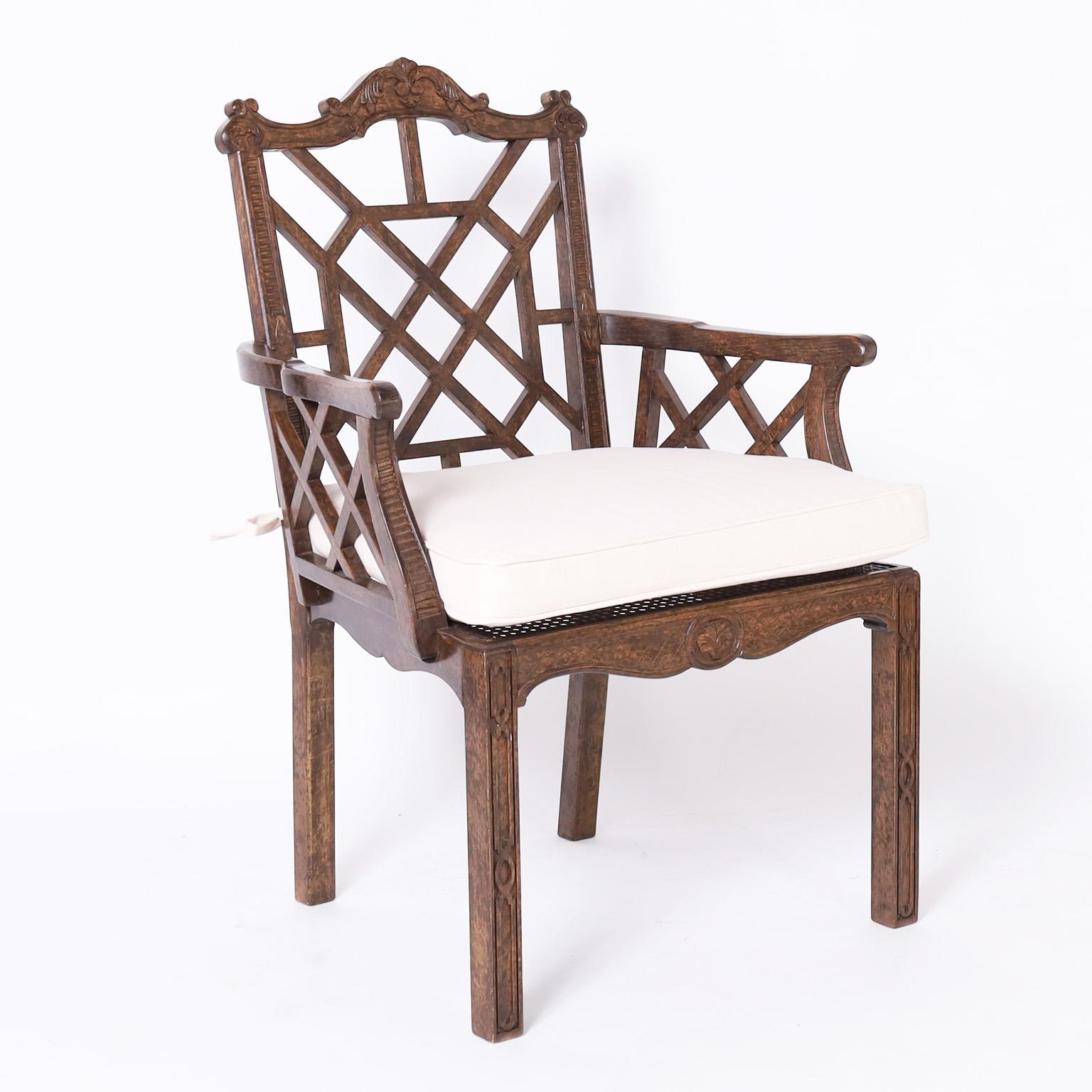 Impressive set of ten armchairs crafted, in the mid 20th C, in beechwood in the Chinese Chippendale manner with a carved serpentine crest rail, lattice panels on the back and sides, caned seats and classic legs.