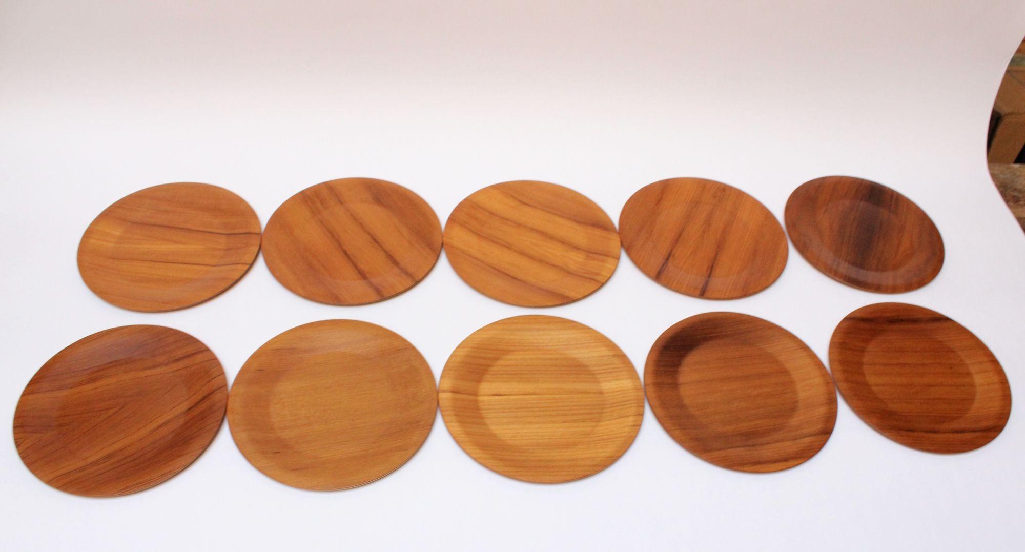 Beautiful and complete set of ten teak plates manufactured in the 1960s by Langva of Denmark.
Slight variations in tone and wood grain along with surface scuffs to some plates, as shown.
Eight of the ten plates retain the 