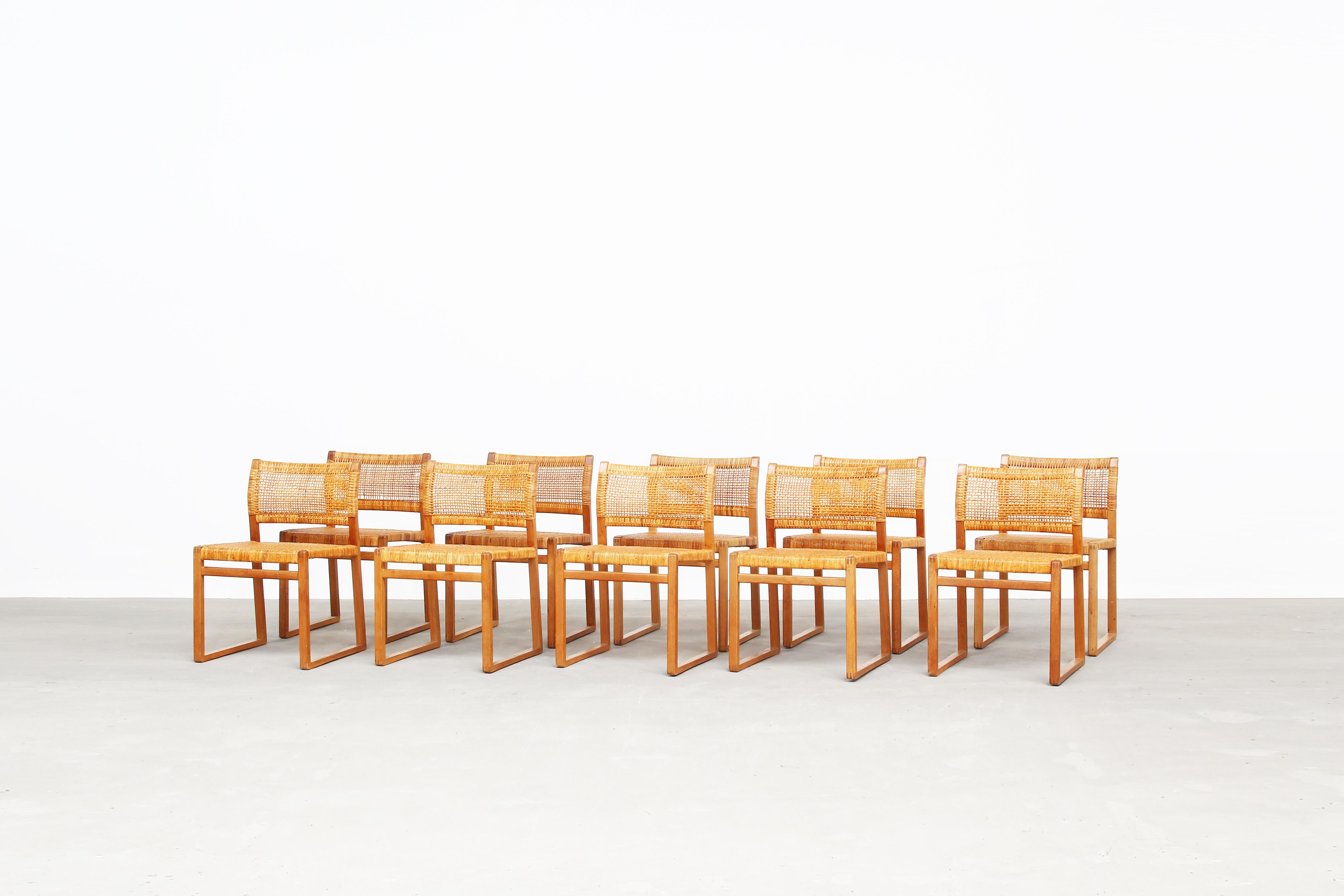 A very beautiful set of 12 dining chairs Mod. BM 61 designed by Børge Mogensen for Fredericia Stolefabrik, Denmark. All chairs are in a very good condition with just little traces of usage. The frame made of oak comes in a great patina. The cane is