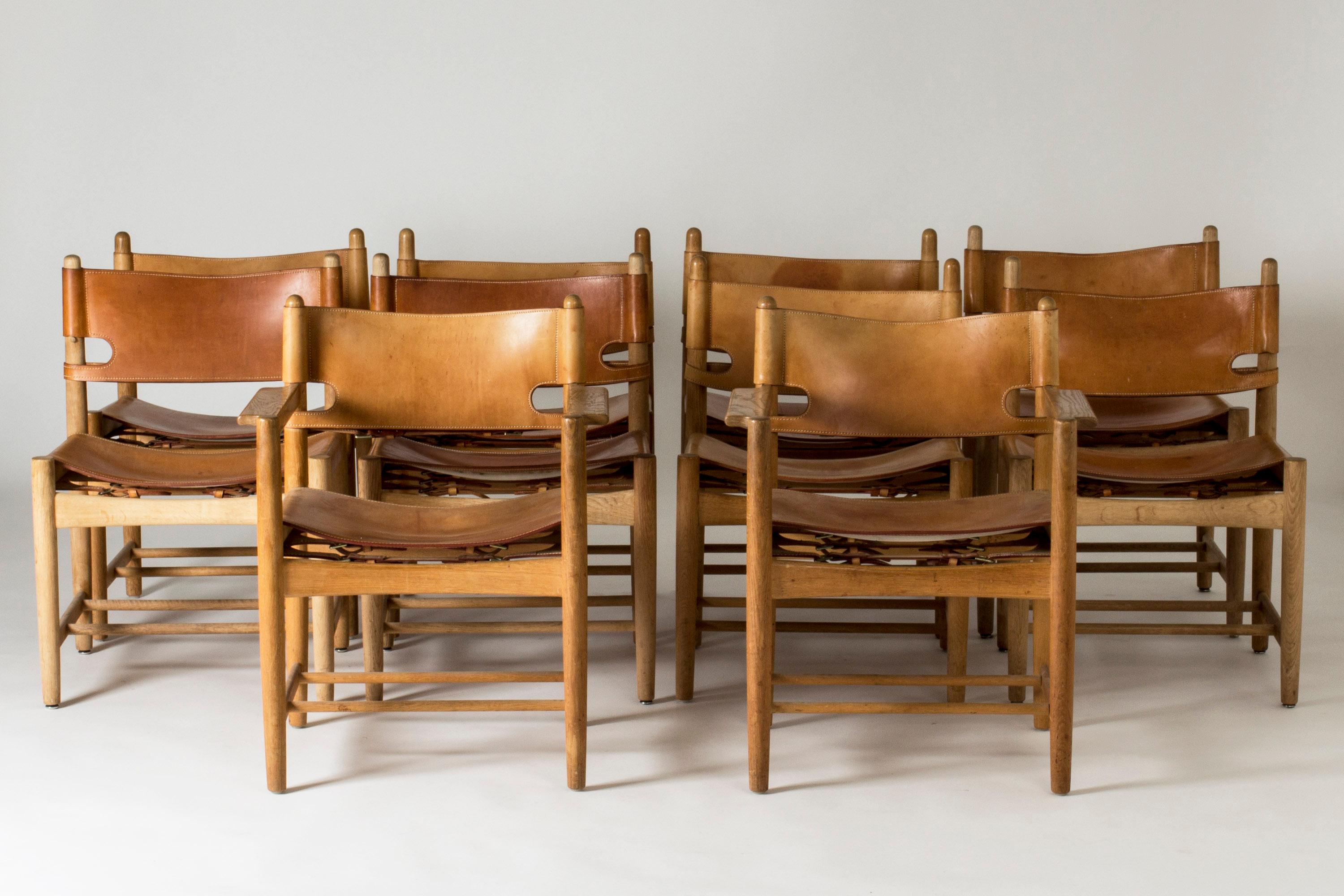 Set of ten dining chairs by Børge Mogensen, including a pair of 3238 armchairs and eight 3237 chairs. Made from oak and leather with accentuated white seams and buckles in the back. A great design, comfortable to be seated in.