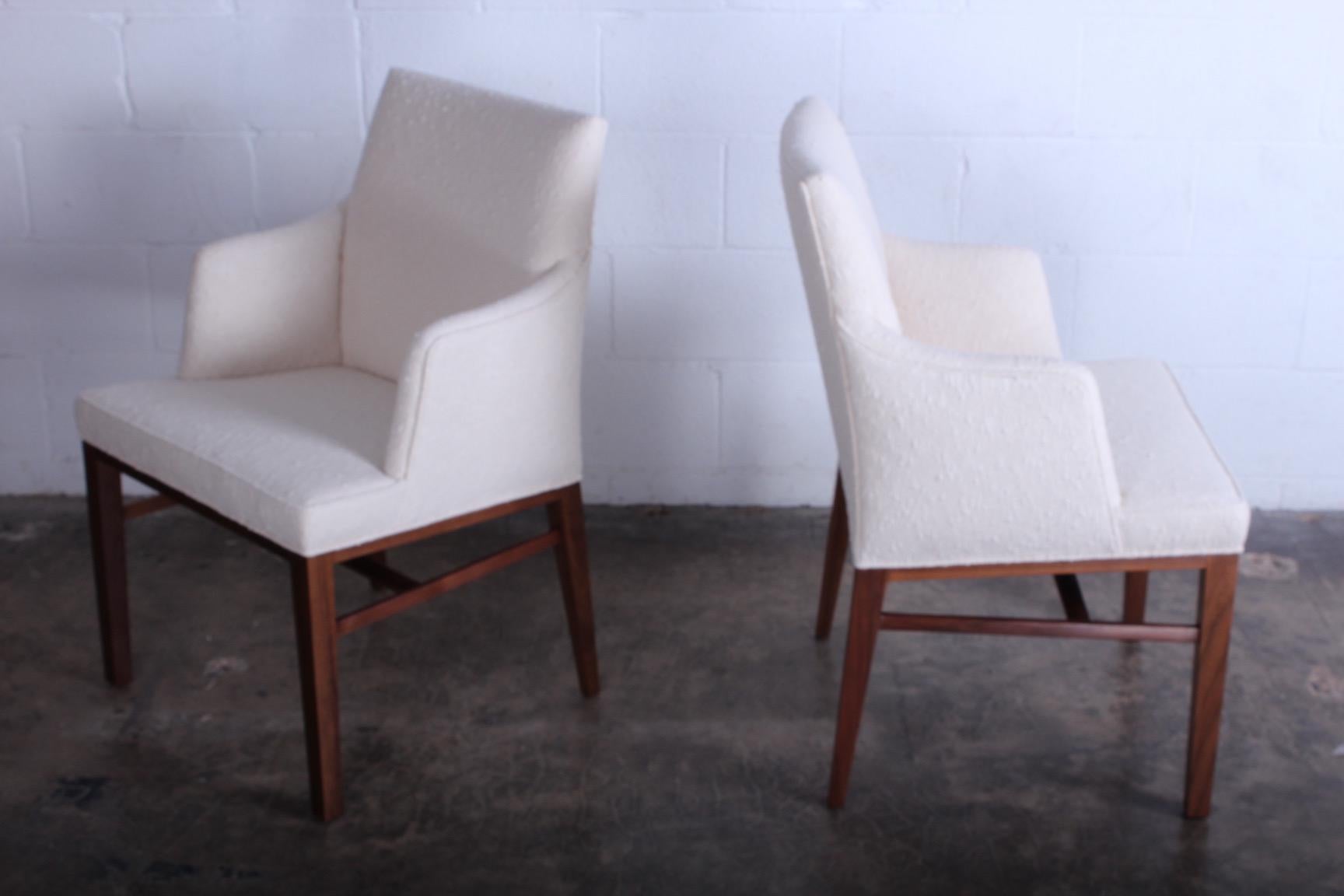 A set of ten dining chairs with walnut bases. Designed by Edward Wormley for Dunbar. Upholstered in Holly Hunt fabric.