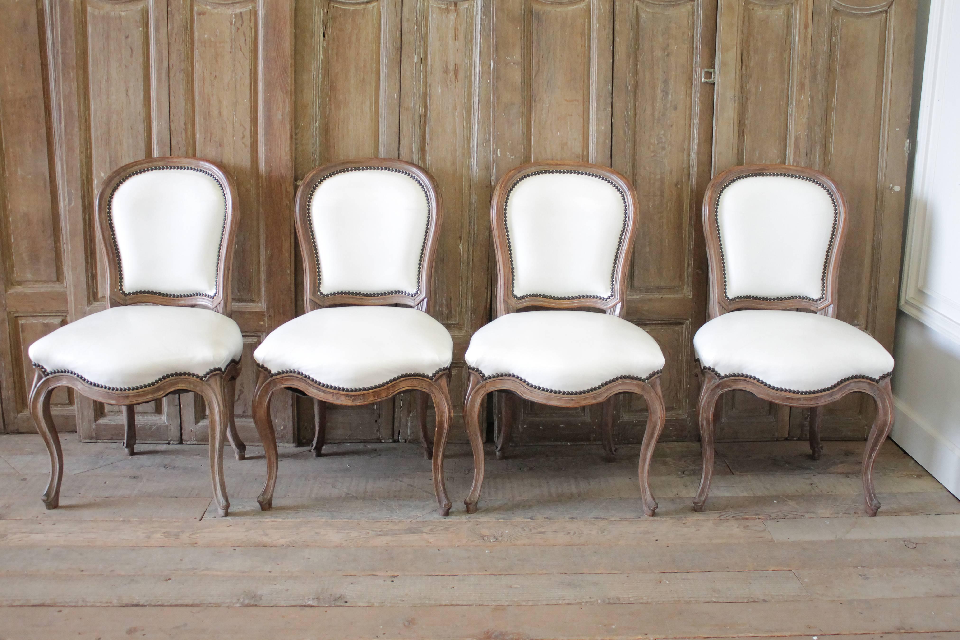 Set of ten early 20th century Louis XV style dining chairs in white leather.
Nine side chairs that measure 21