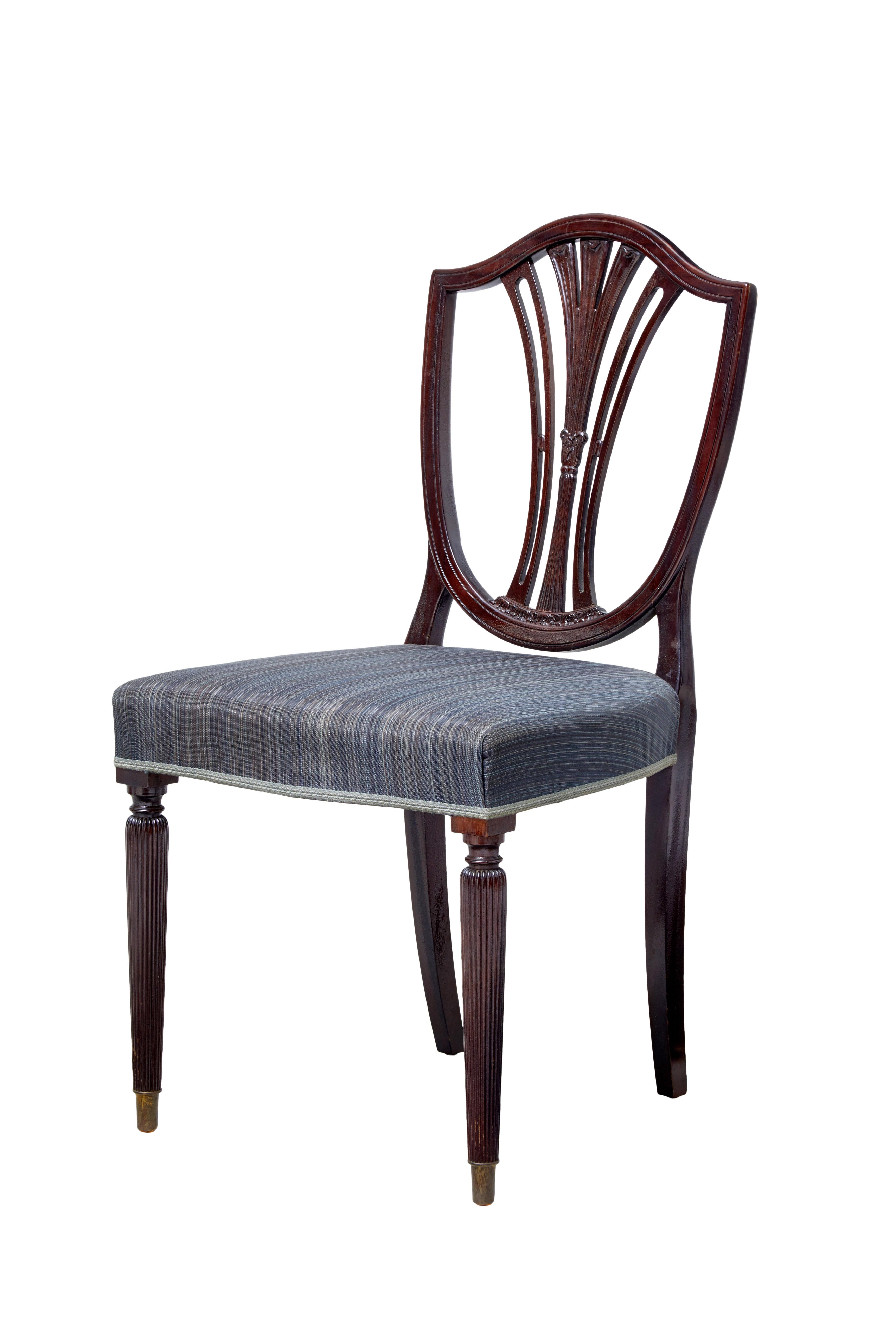 Sold as a set of ten but in fact there is 11 of these chairs in this set, circa 1900.

Desirable shield back rests with pierced detailing. Over stuffed seats.

Standing on front fluted legs and tapering back legs.

Ideally in need of