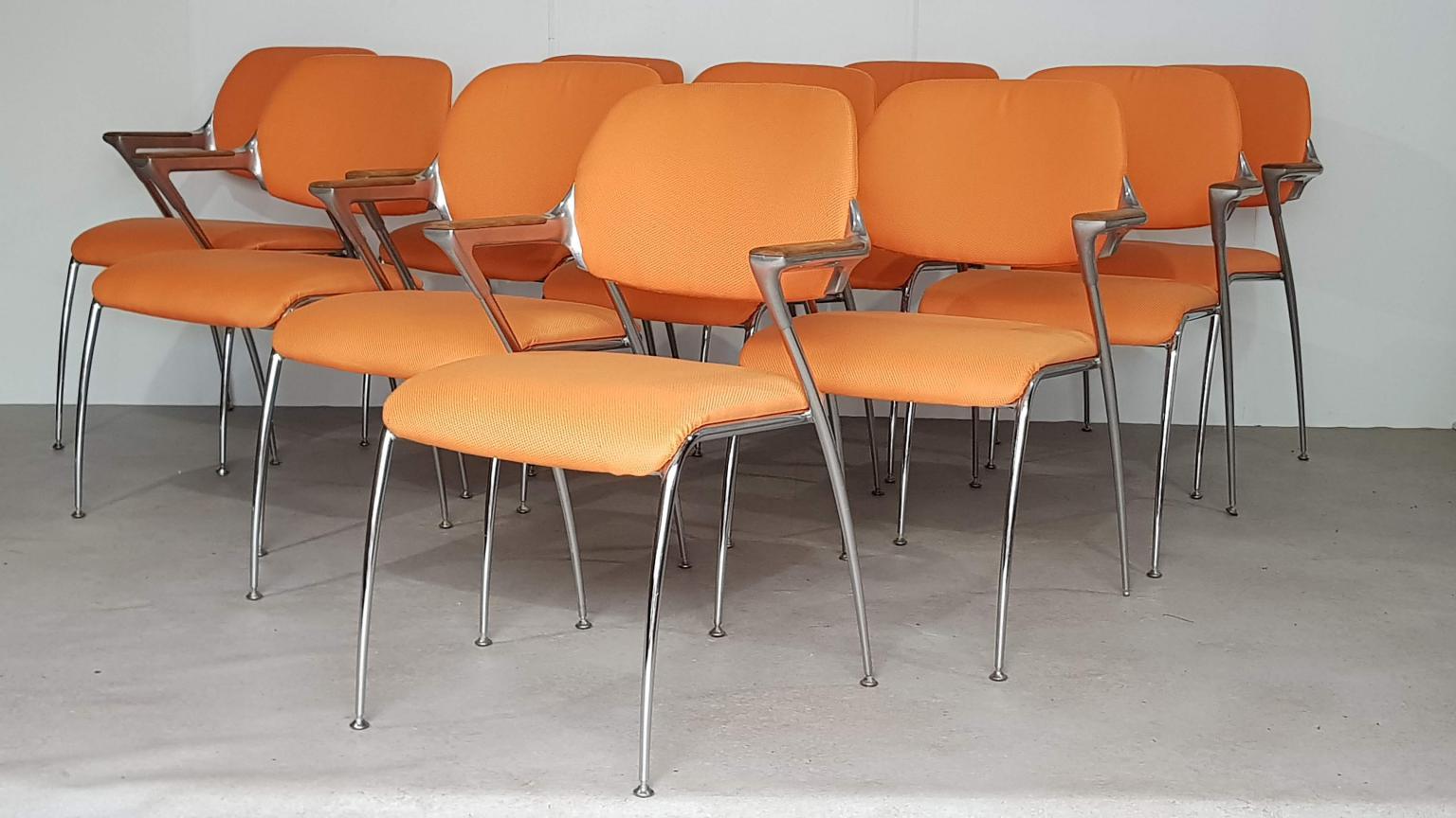 Ten Francesco Zaccone for Brunner “Golf” dining chairs.

Stacking chairs. Metal frame with wooden armrests, orange upholstery.

Measures: Width: 58 cm, seating 45 cm
Depth: 50 cm, seating 45 cm
Height: 82 cm, seating 45 cm.