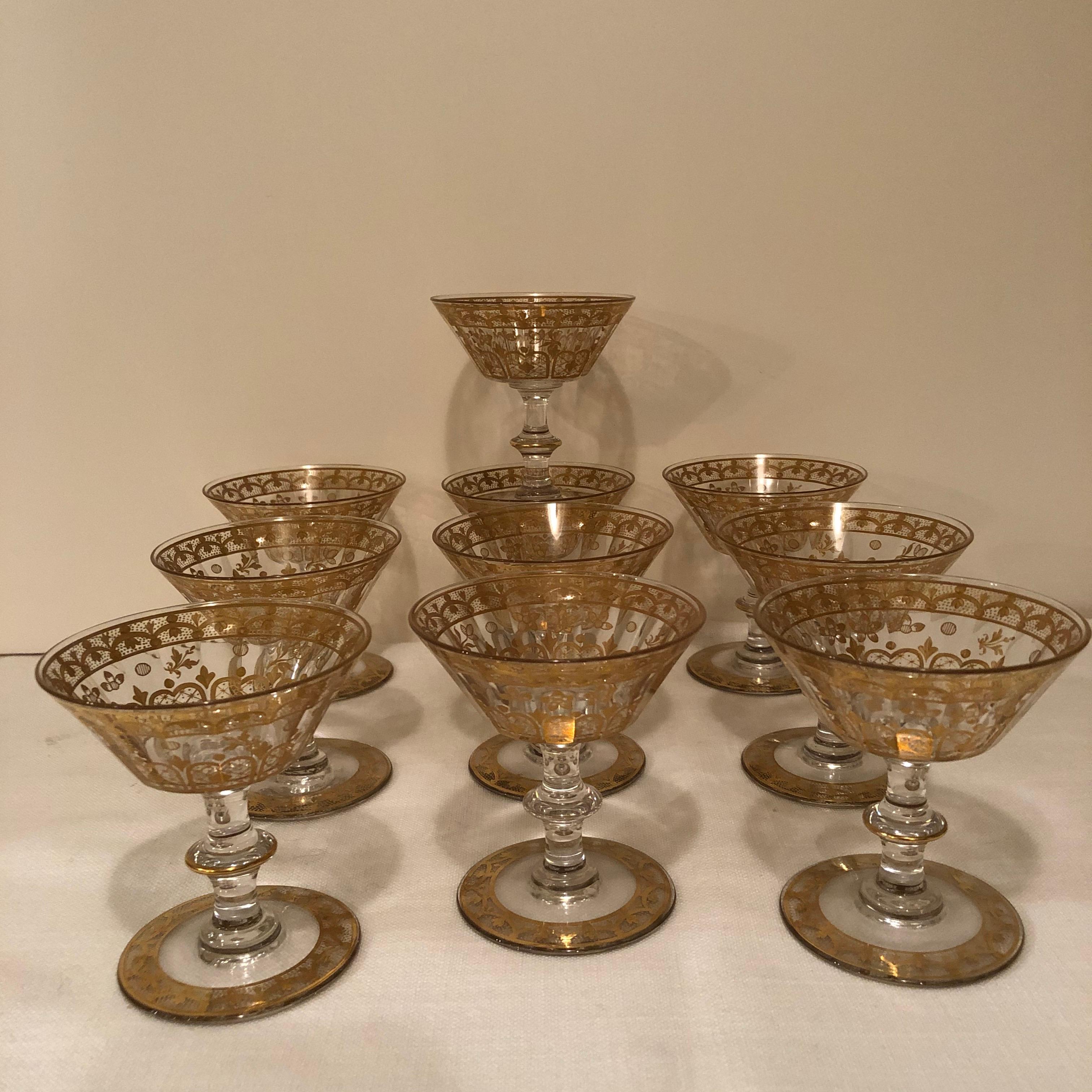 Set of ten French crystal and gilded stunning coupes or champagnes. When you hold one of these coupes up to the light, you can see eighteen facets in the glass. They are from circa 1900-1920. These champagne coupes have been the latest drinking fad