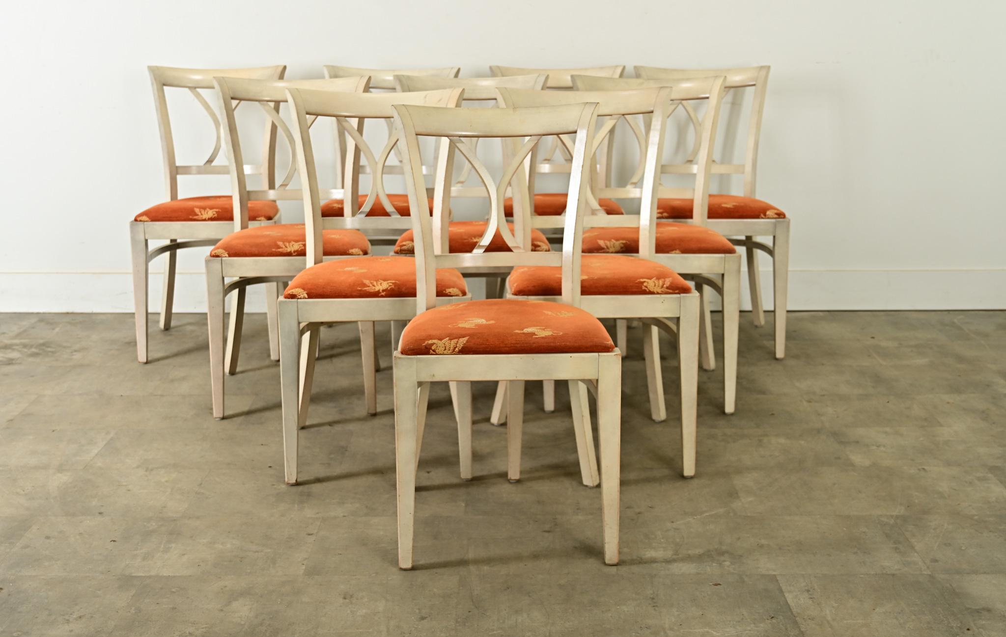 A set of ten vintage French chairs from a bistro or brasserie, exhibiting a harmonious blend of Regency elegance with modern functionality. This chair design features a solid wooden frame with contoured handrail over a minimal splat that conveys a