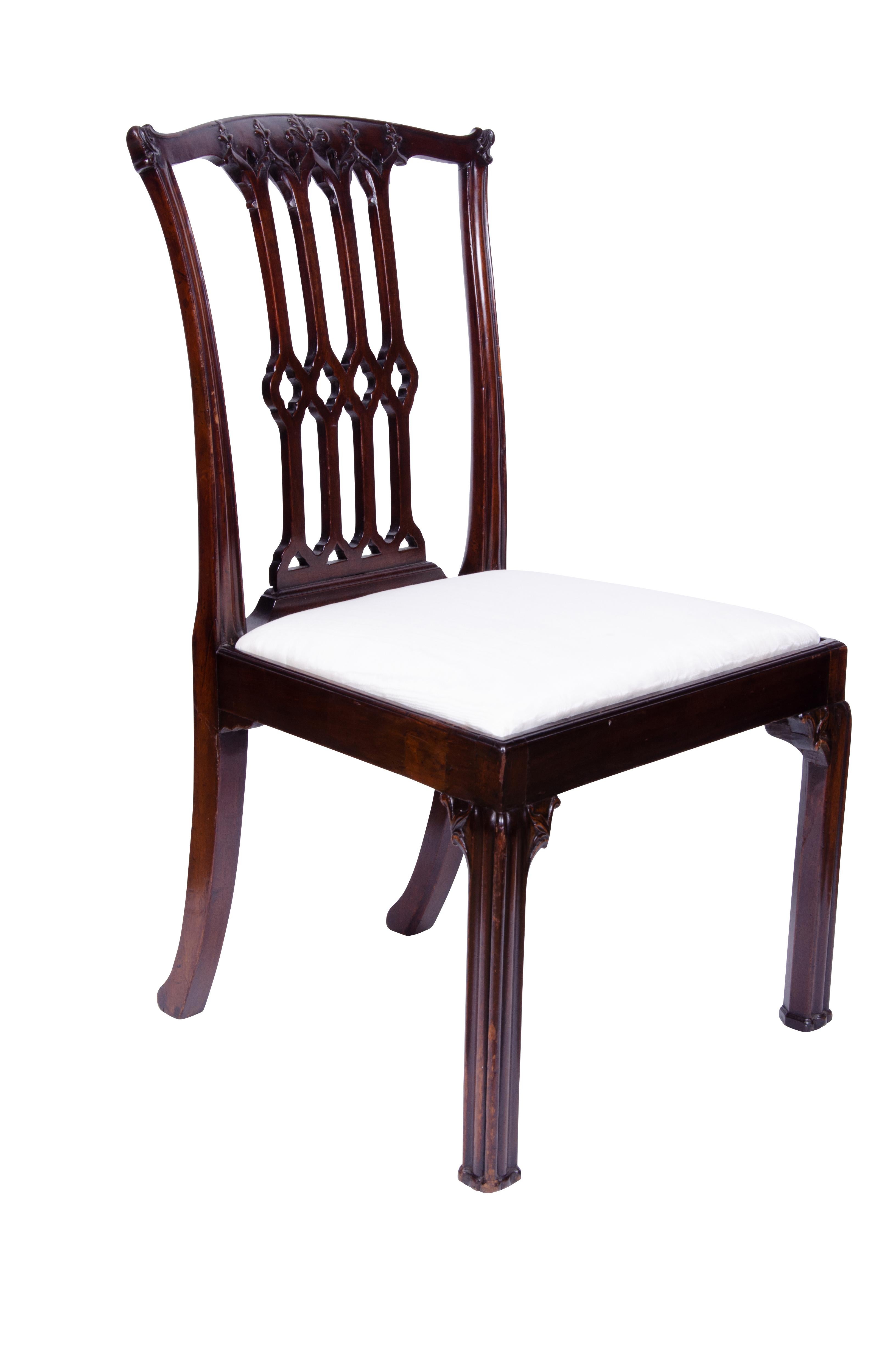 Chippendale period chairs with dealer labels of Norman Adams noted London dealer of the finest English furniture. Gothic revival pierced backs typical of Chippendale, slip seat for easy reupholstery. Molded cluster column legs. A book 