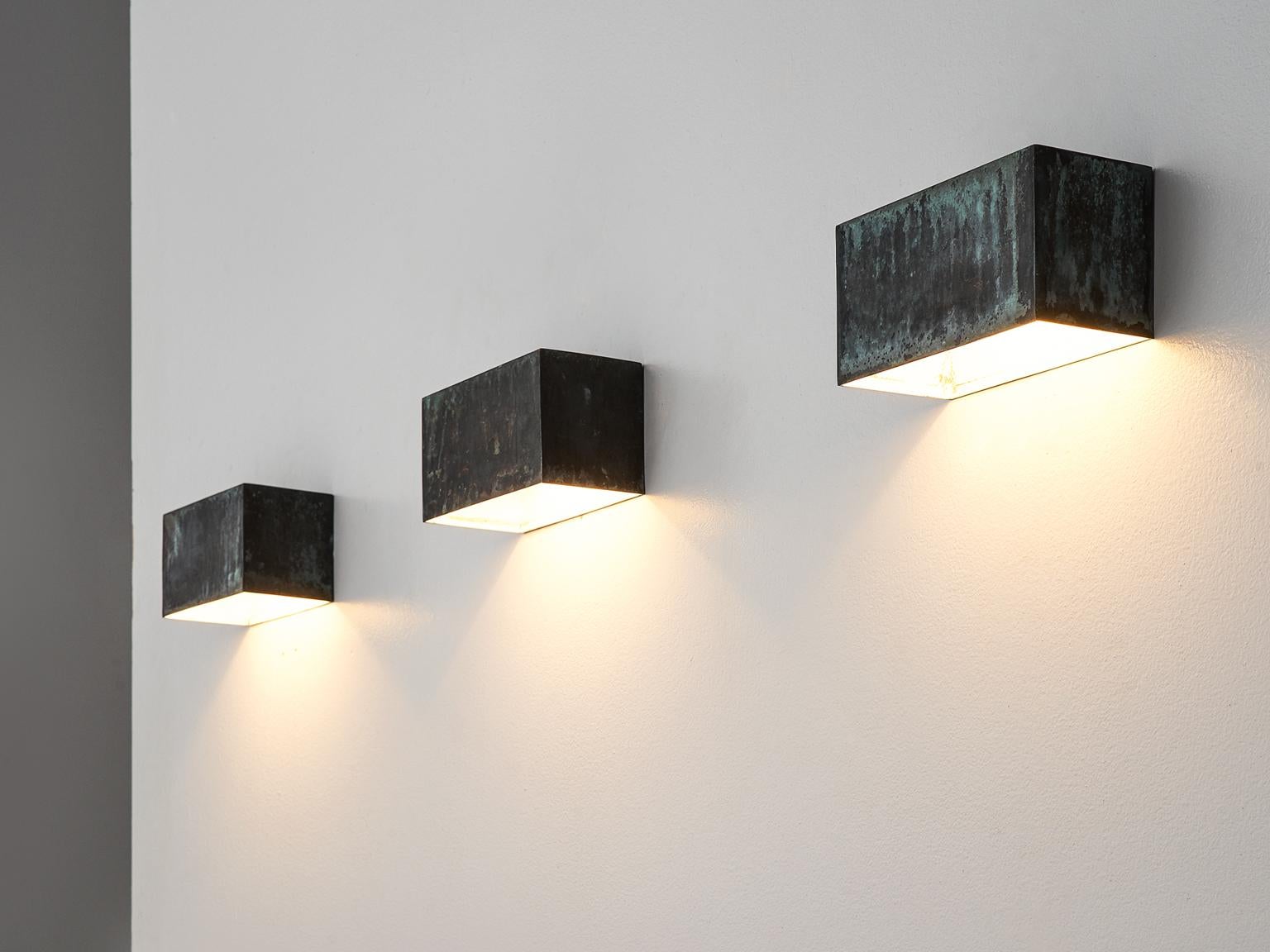 Hansson & Co., wall lights, copper, Sweden, 1960s. 

This large set of wall lights is designed by AB E. Hansson & Co. These geometric patinated lights feature traits of the style of Hans-Agne Jakobsen. The set is simplistic and qualitative and