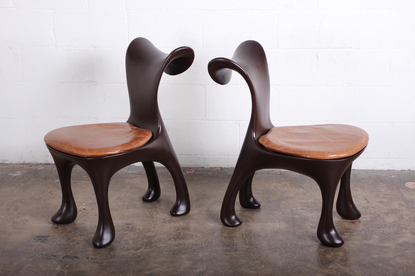 A set of ten 'Hoodie' dining chairs designed by Jordan Mozer for the Américas Restaurant in Houston, TX. These have been restored and color-matched to the original flat chocolate brown lacquer. The original leather cushions have a wonderful patina.
