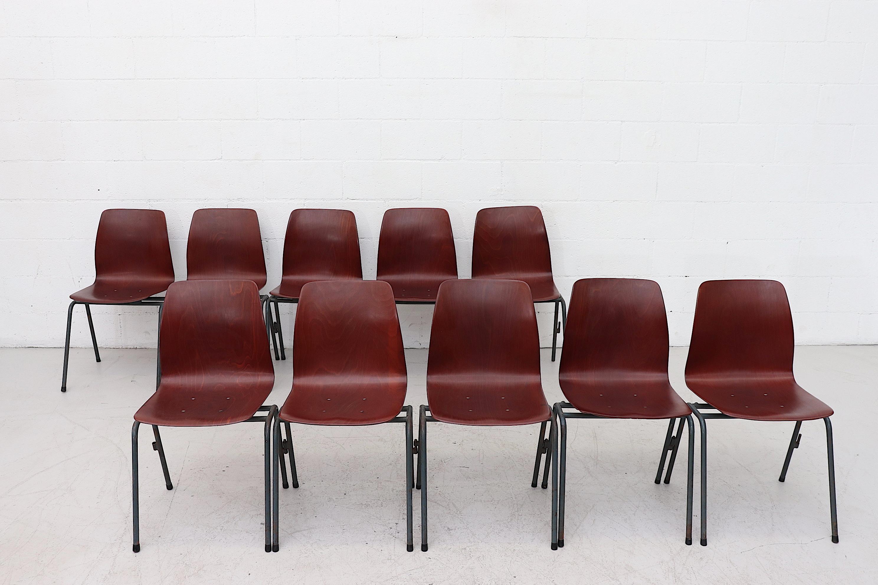 Handsome, mid-century, reddish teak toned, single shell seat chairs with  teal blue enameled metal frames. Most of these chairs still retain the original side hooks that are used  for creating rows of chairs. All chairs in very original condition