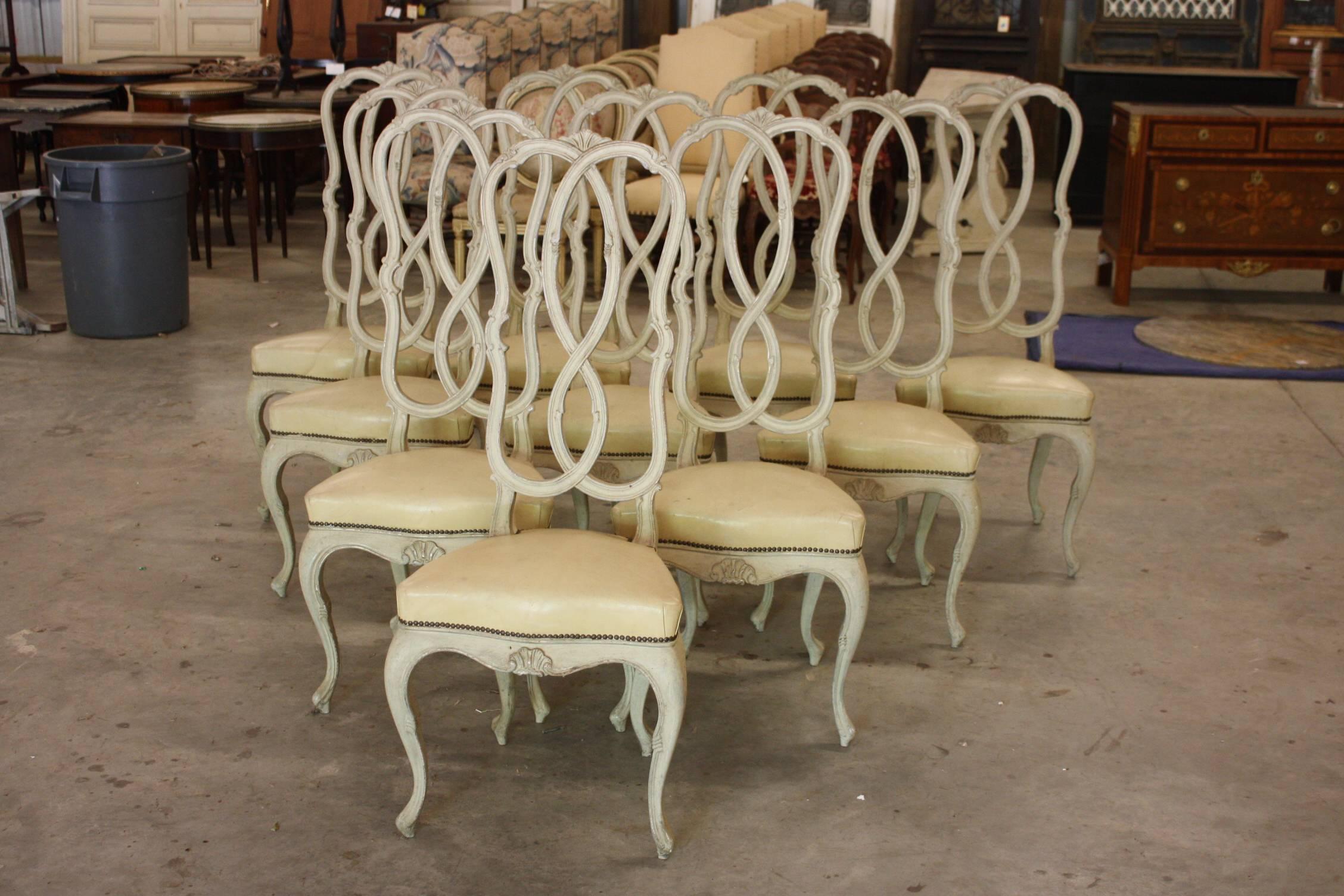 A set of ten Venetian style painted wood dining room chairs with nicely carved back, cabriole legs, seats upholster in leather.