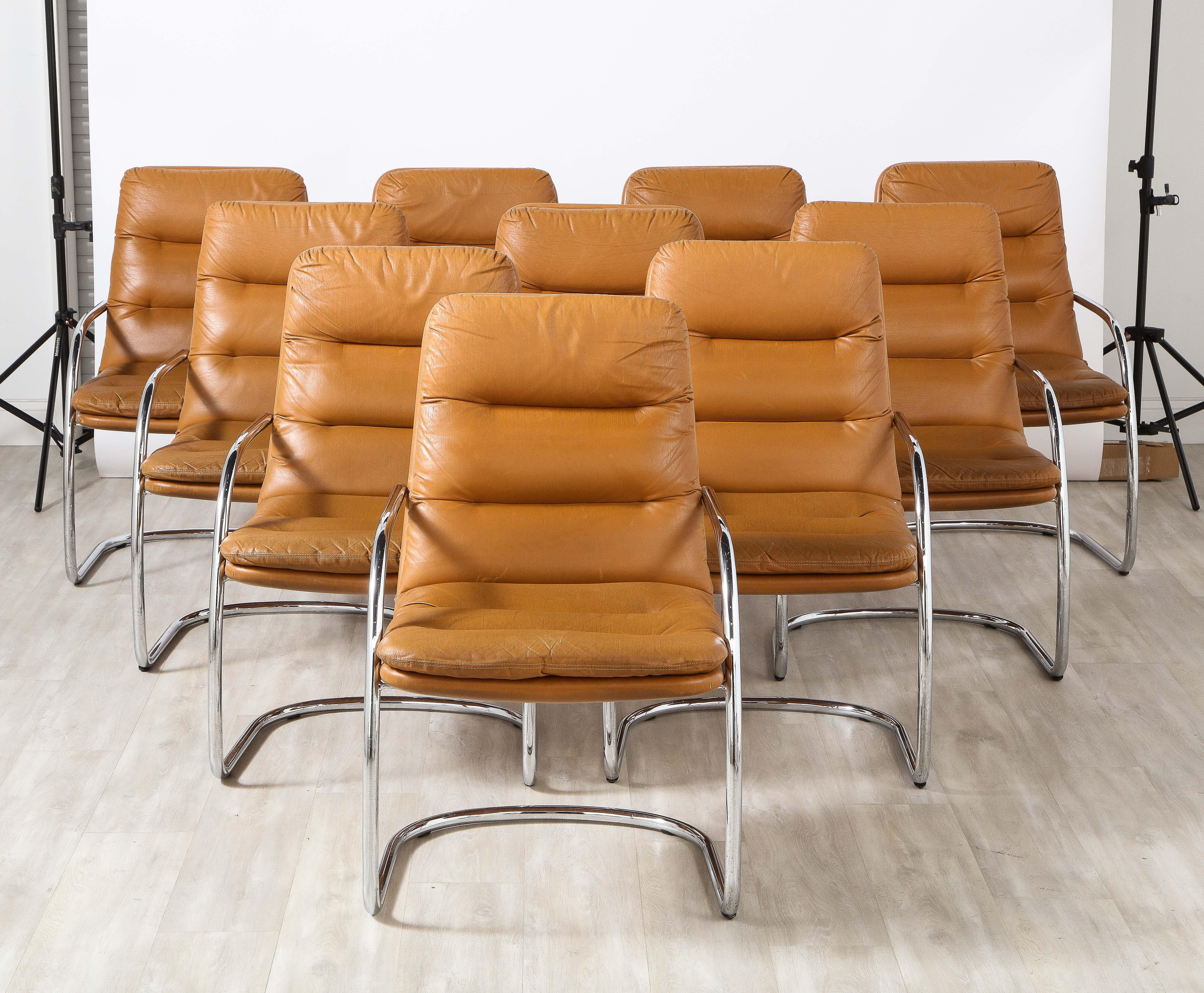 A set of ten armchairs in beautiful caramel leather with polished chrome frames. The seats and backs are covered completely with the rich and supple caramel colored Italian leather and are attached to graceful polished steel tubular frames. Perfect