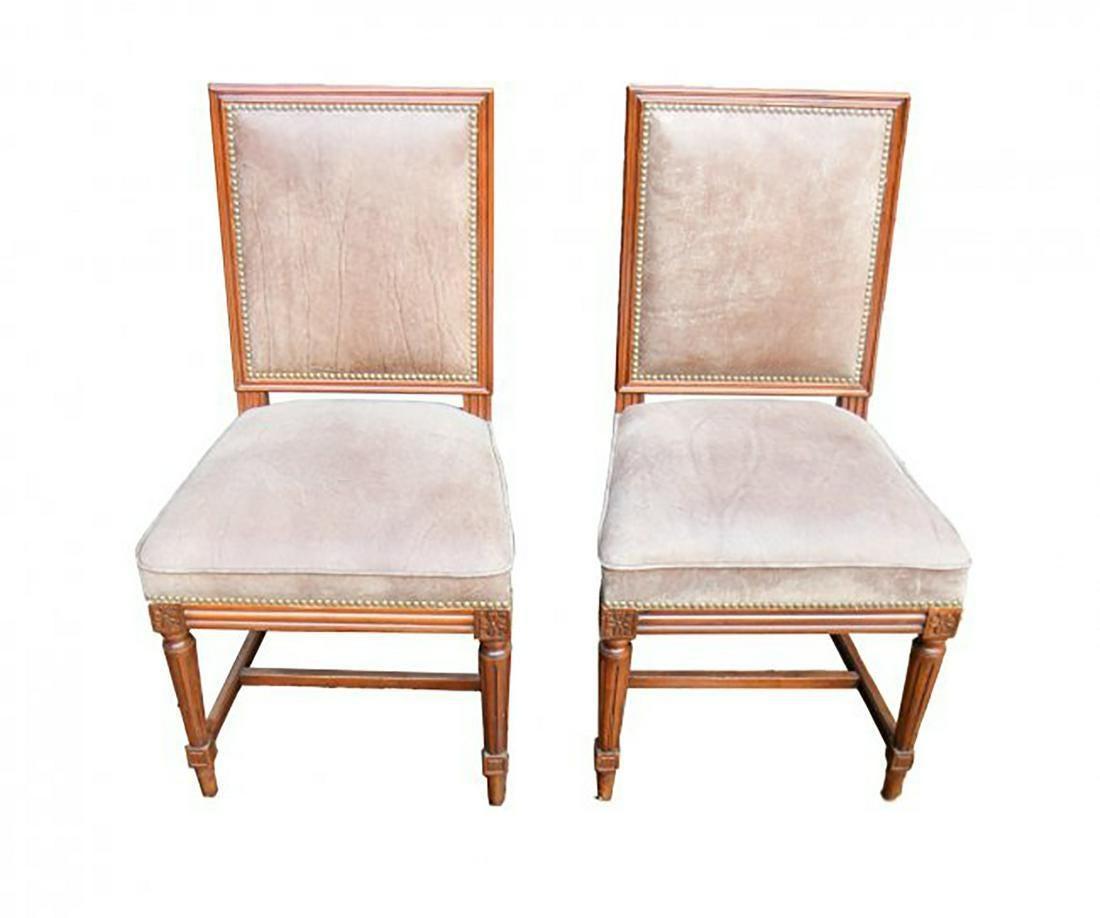 Set of ten Jansen manner Louis XVI style walnut wood dining side chairs with distressed brown leather seats and backs.