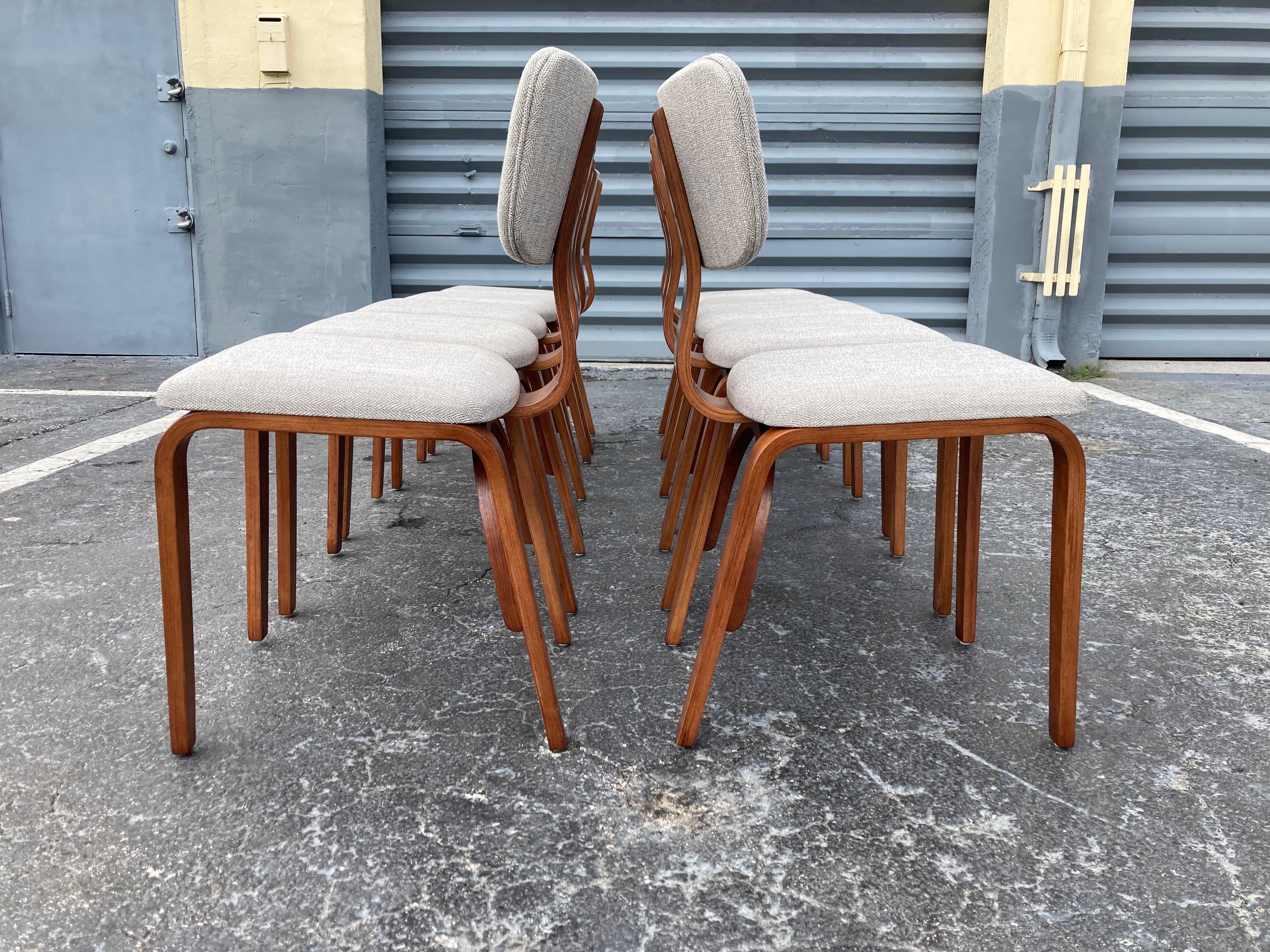 Set of ten chairs designed in 1950's by Joe Atkinson for Thonet, USA, Birch plywood with a walnut finish. Fabric is new. Ready for a new home.
