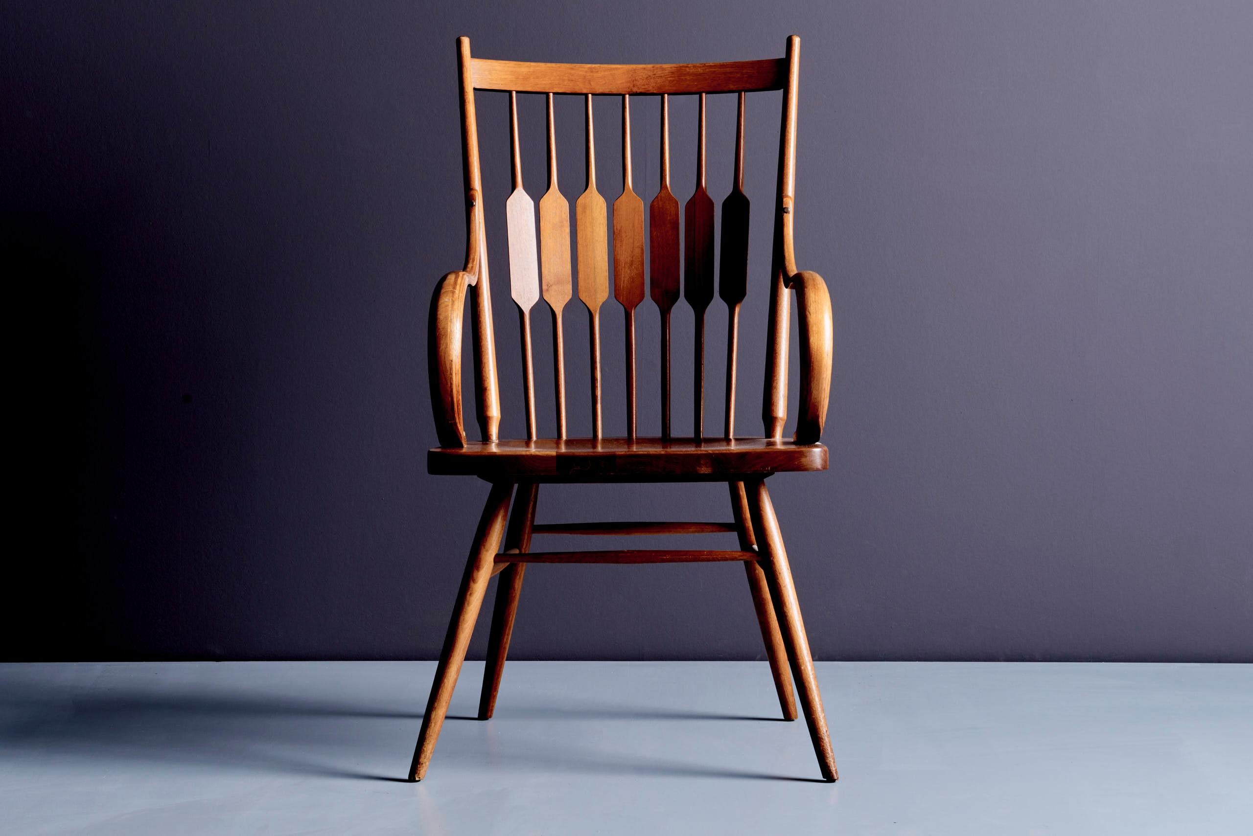 Set of vintage Drexel dining chairs in solid walnut. Features splayed legs, flat seats, and spindle backs with sculptural geometric slats. Includes side chairs and armchairs. The design reflects an American mid-century aesthetic, often seen in