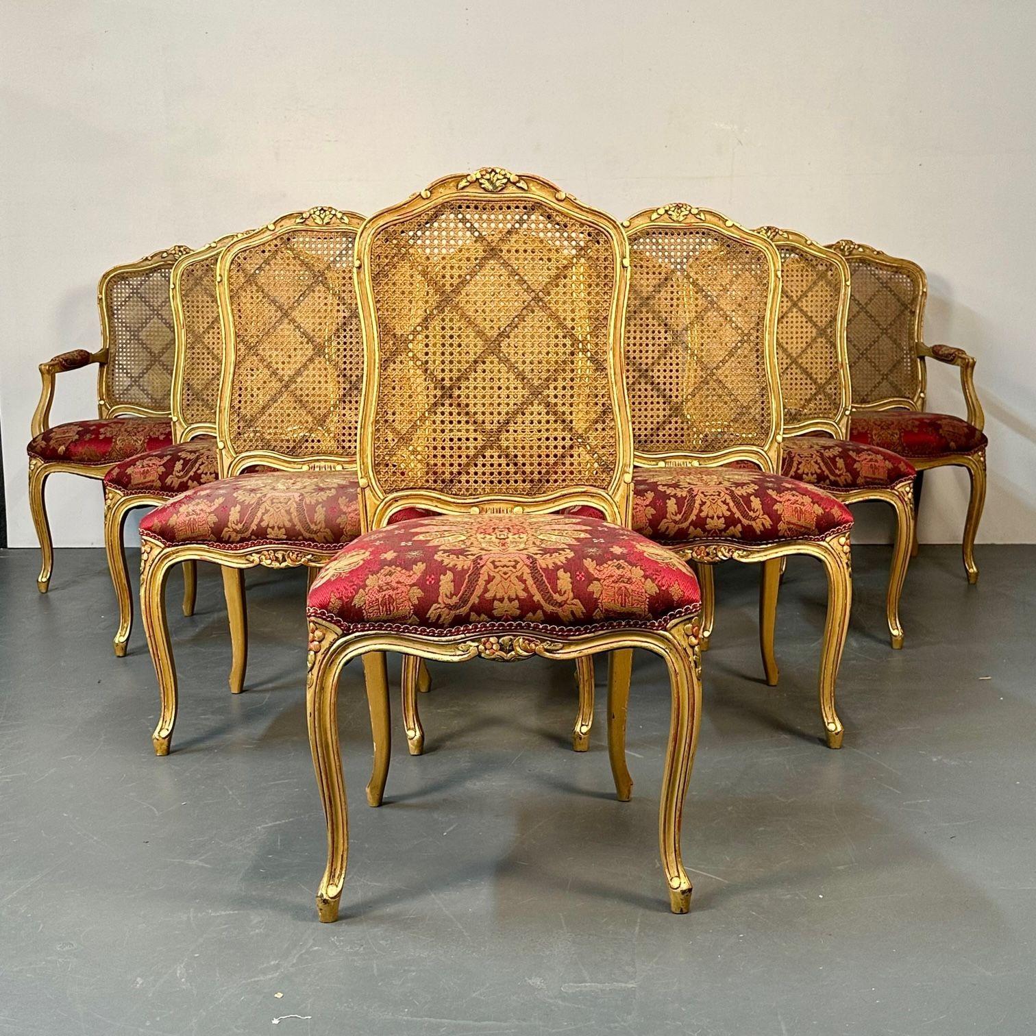 Set of Ten Louis XV Style Dining / Side Chairs, Clayed Gilt and Cane
 
A stunning set of finely carved and upholstered dining chairs, Mid-20th century, comprised of two armchairs with floral-carved cartouches and caned backs, raised on cabriole