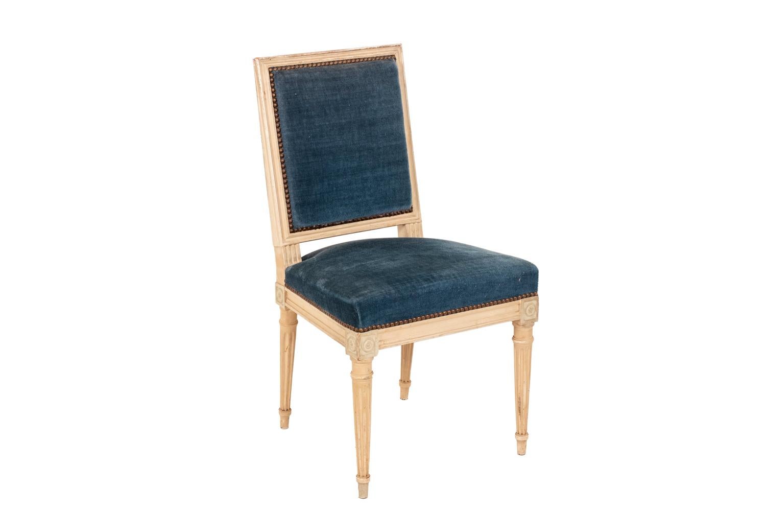 Set of 10 Louis XVI style chairs in white lacquered wood. Fluted tapered legs. Molded straight back. Seat and back garnished with padded blue velvet.

Work realized in the 1950s.
  