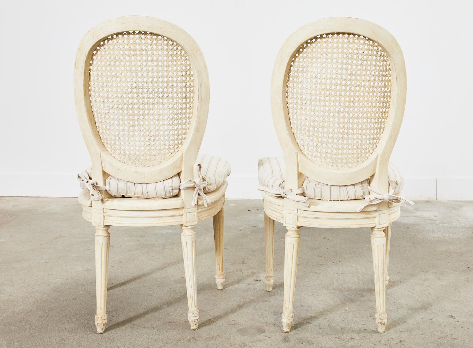 Set of Ten Louis XVI Style Painted Cane Dining Chairs 14