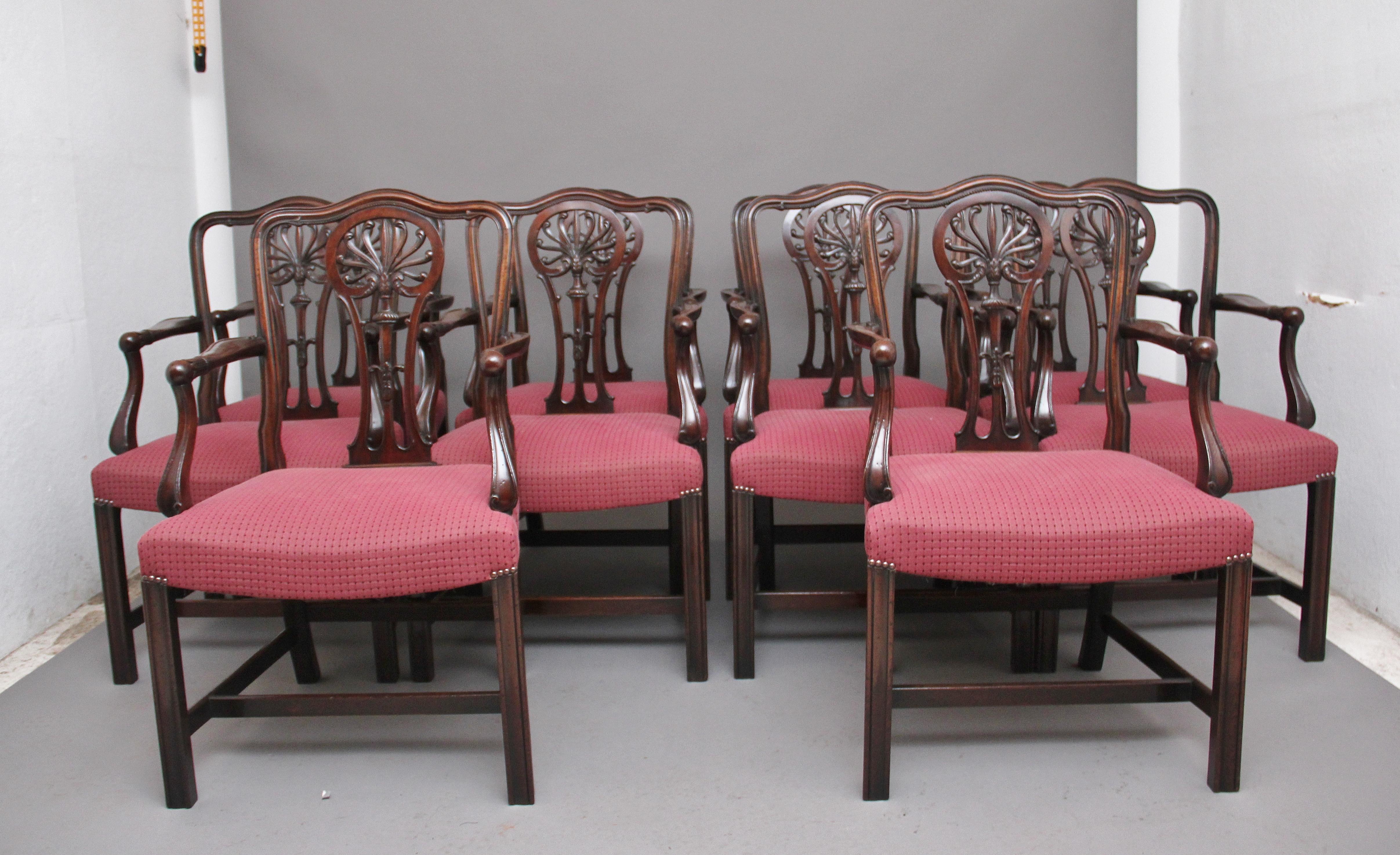 A set of ten early 20th century mahogany armchairs by Alfred Allen Furnishings of Birmingham, with a decorative carved & pierced splat in the back, the slender curved supports with carved floral decoration on the front of the arms, with a red stuff