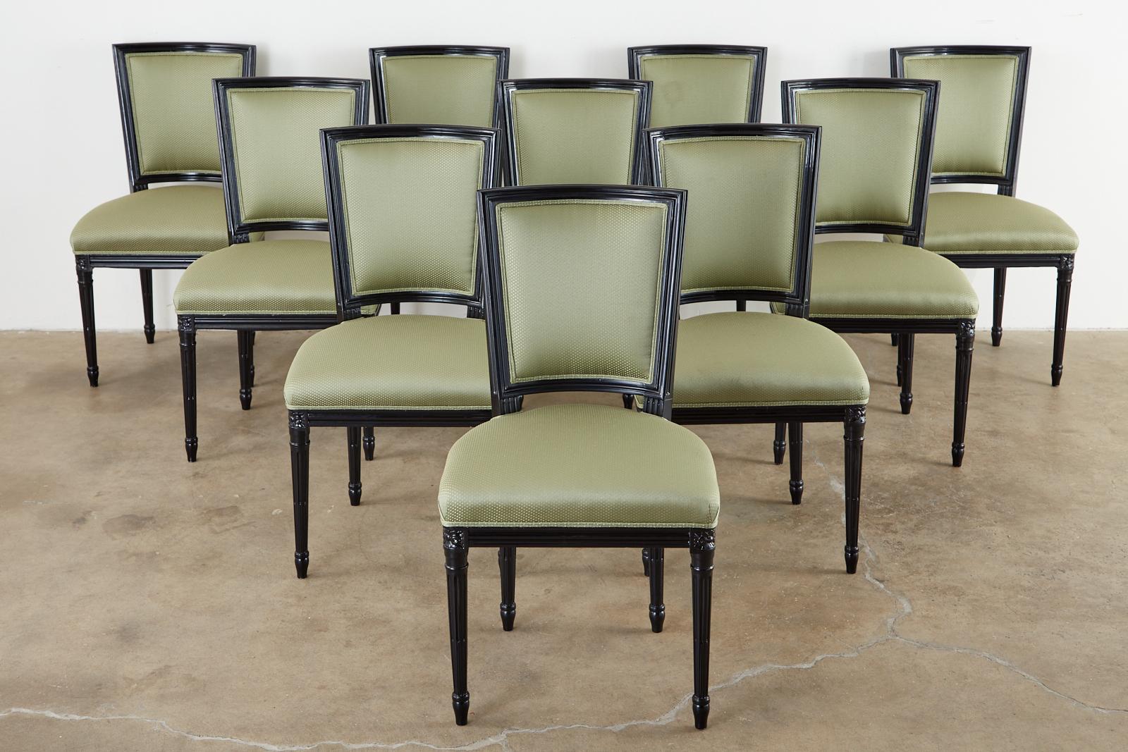 Dramatic set of ten black lacquered dining chairs made in the grand French Louis XVI taste. Attributed to Maison Jansen from the estate of Roger Prigent Malmaison, New York. Upholstered with a pistachio green fabric having gilt specks. The frames