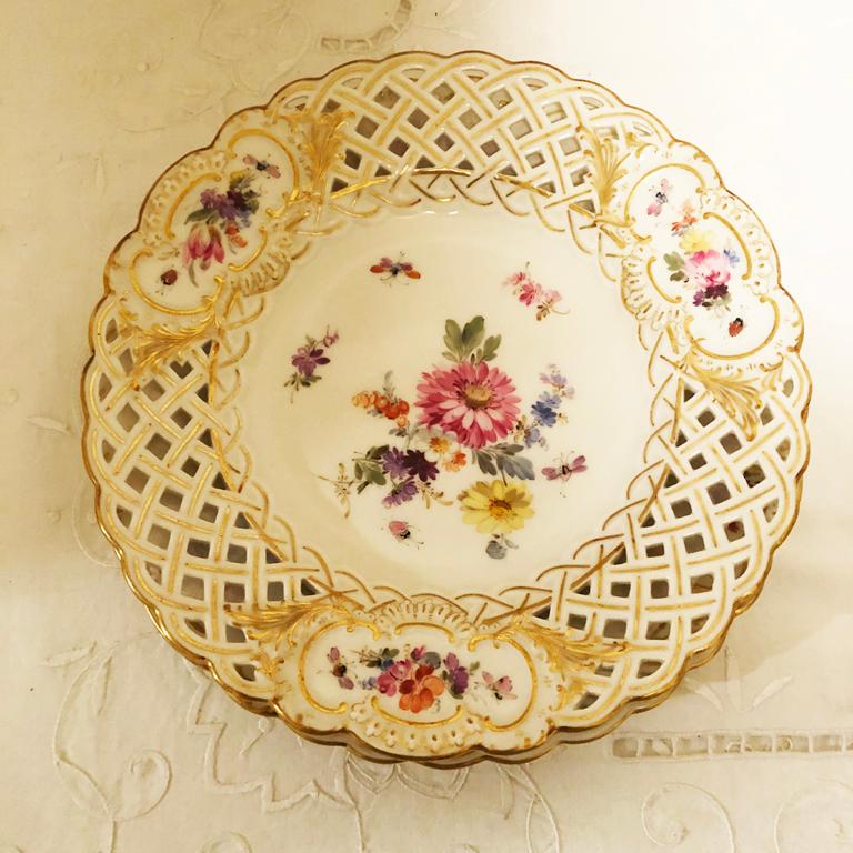 We are offering a set of ten Meissen reticulated dessert plates. Each one of these openwork o Meissen plates are hand painted with different beautiful flower bouquets of spring and summer flowers and insects. You can see that the artwork is