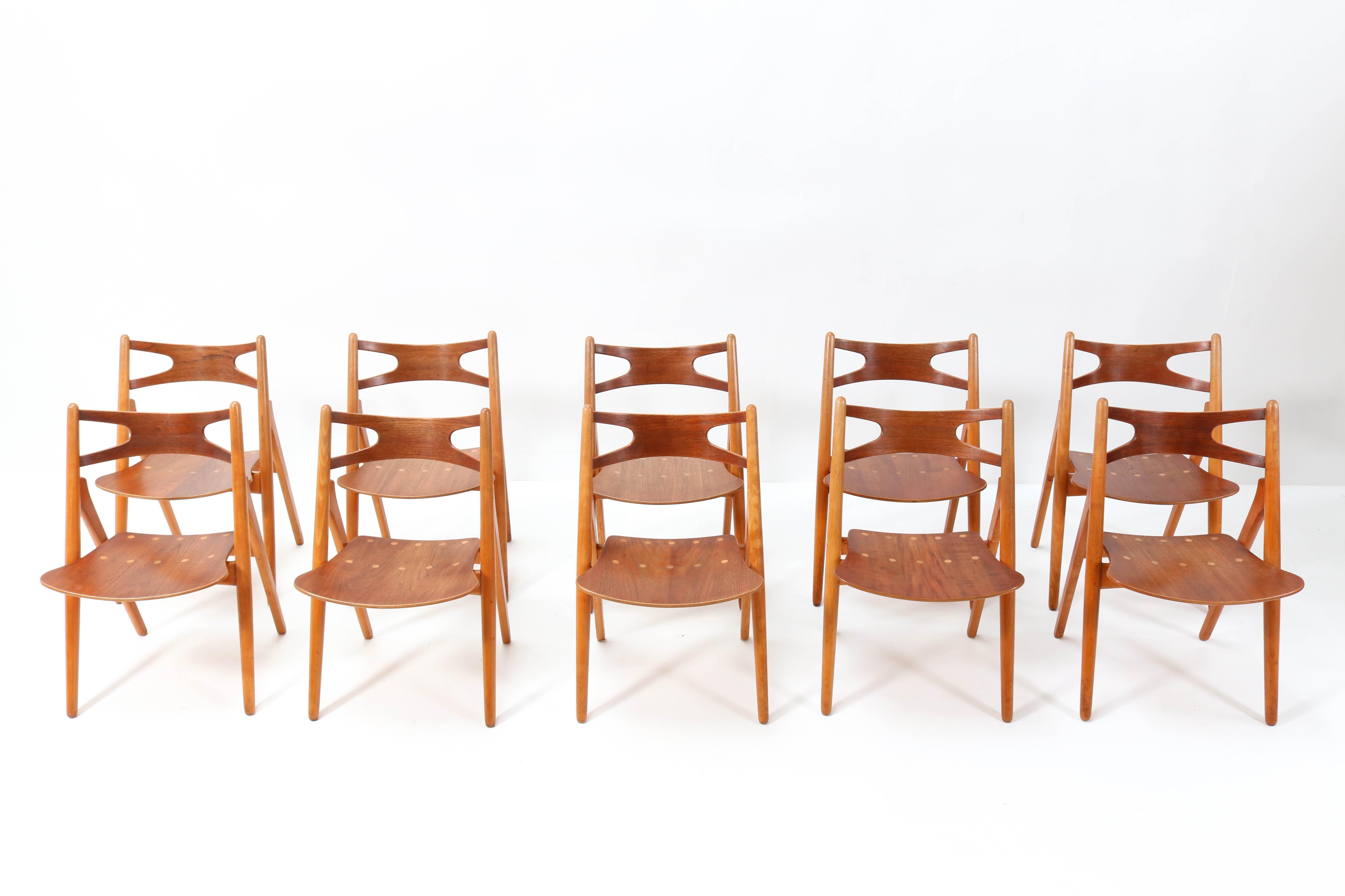 Magnificent and rare set of ten Sawbuck CH-29 chairs.
Design by Hans J. Wegner for Carl Hansen & Søn.
Striking Danish design from the 1950s.
Solid beech frame with original teak veneer seat.
One of the ten chairs is marked with the manufacturers