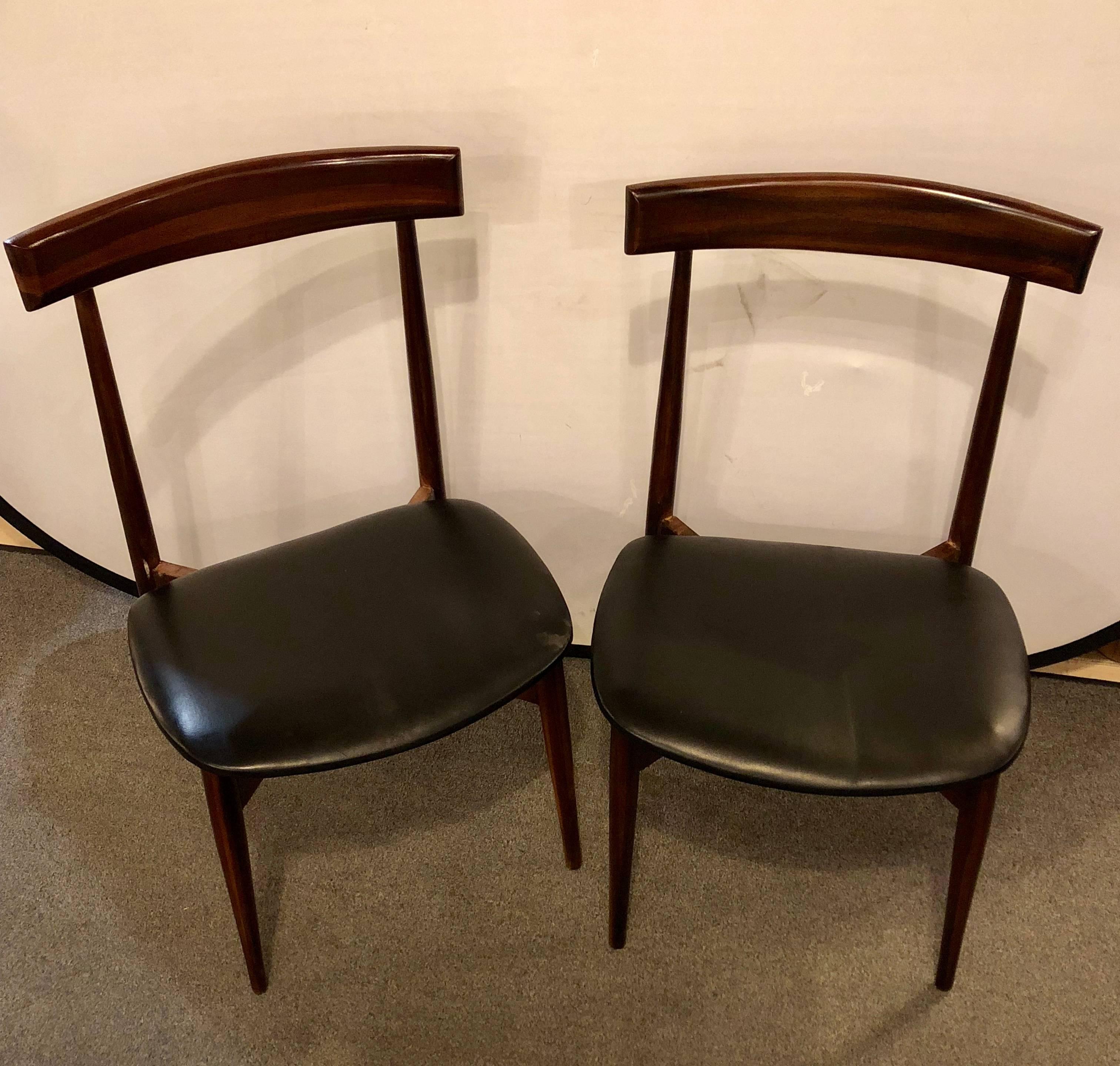 Set of ten Mid-Century Modern slat back black leather dining chairs. Each in a rosewood finish with new seat cushions.