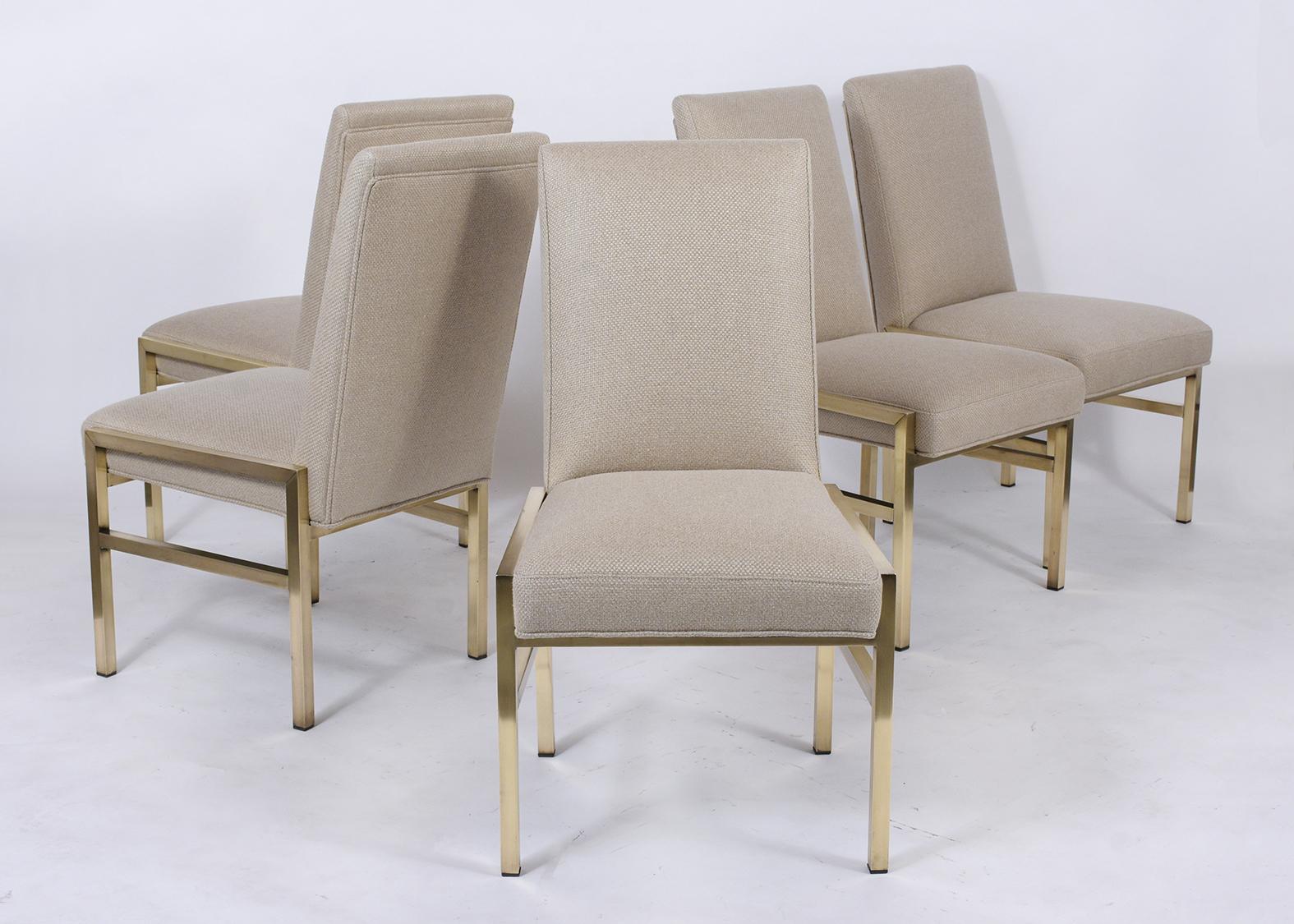 A remarkable set of ten Mastercraft dining chairs that are fully restored and feature a sturdy brass chair frame. This set of chairs has also been professionally reupholstered in a beige color wool fabric with topstitch details, slanted high