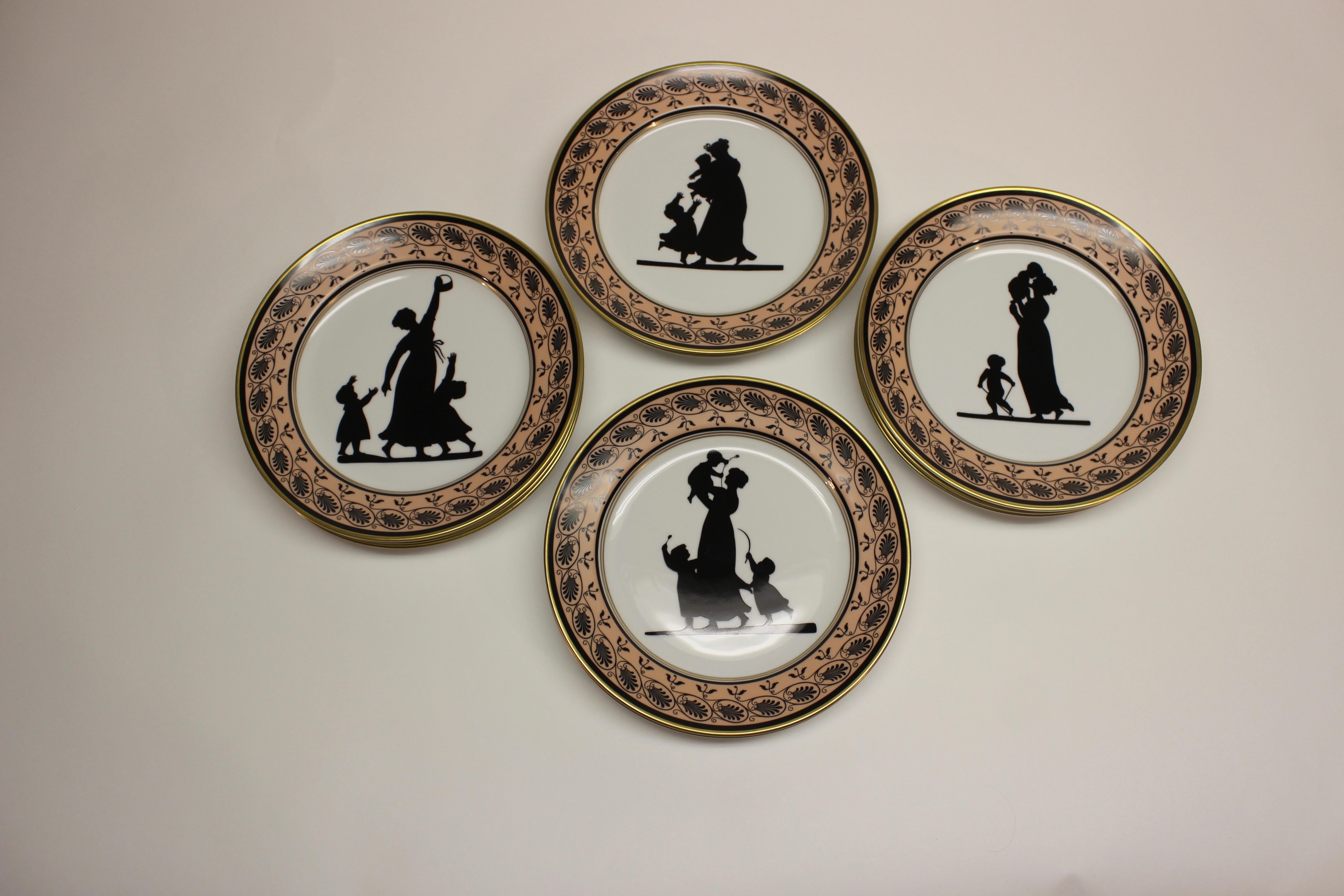 Vintage Mottahedeh Vista Alegre silhouette dessert plates with a decorative pink and black border. The plates are Motthahedeh copies of an early 19th century Coalport design featuring members of the Angerstein family in silhouette circa 1805-1810.