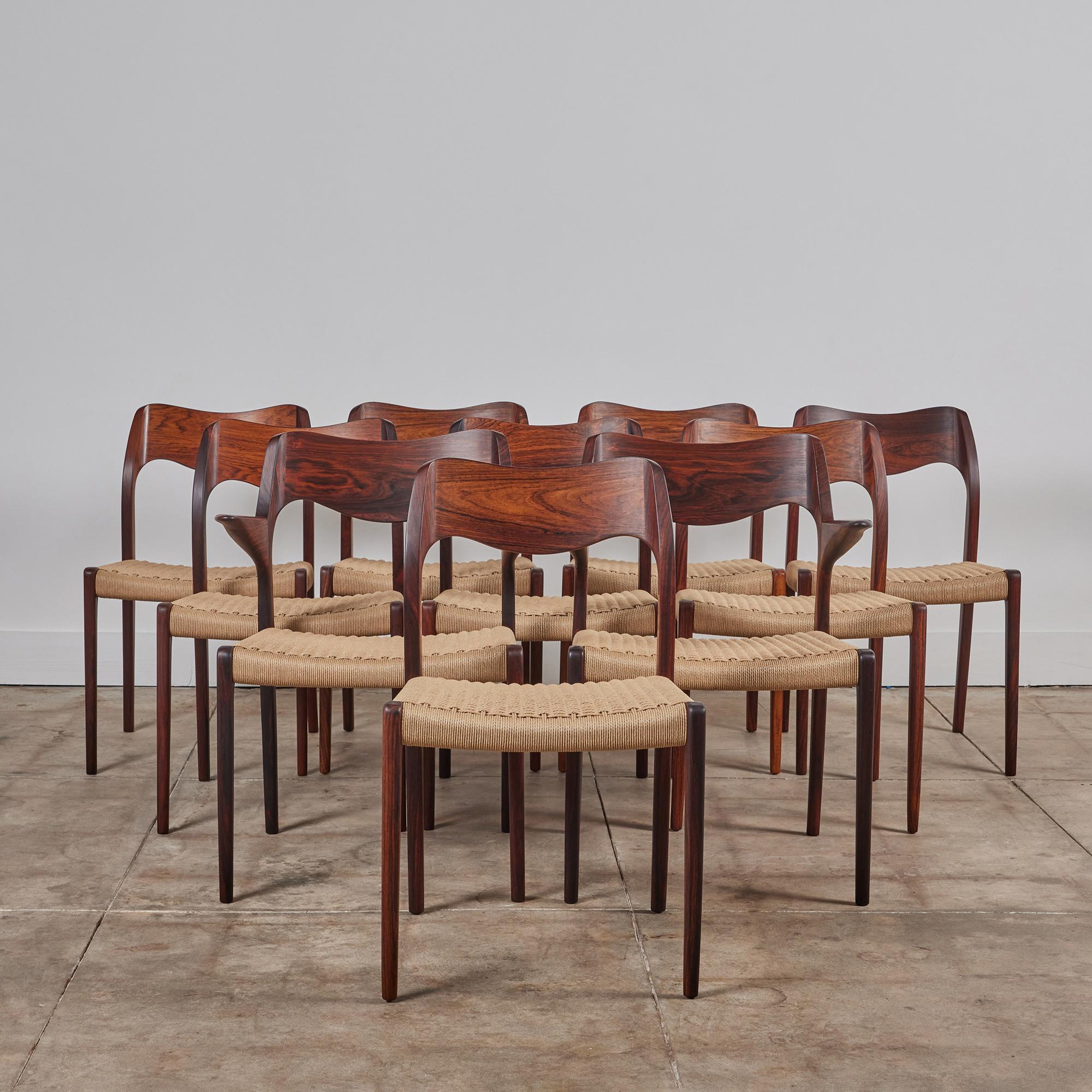 Set of ten Niels Møller Model No. 71 and No. 75 dining chairs in solid rosewood with Danish paper cord seats. Designed in 1951 and produced by J. L. Moller Mobelfabrik. The chairs feature a solid wood frame that is impeccably shaped. Møller often
