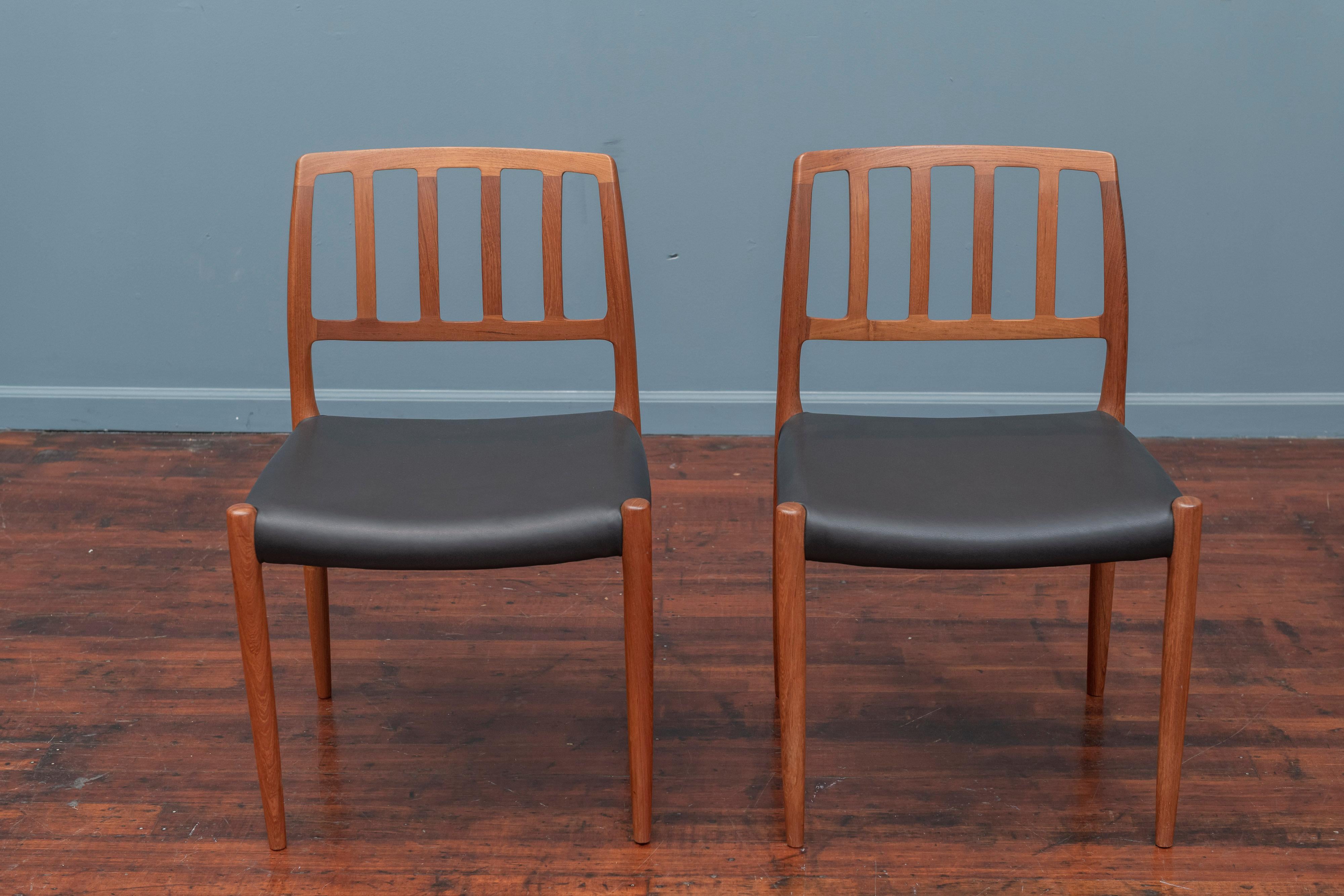 Set of ten Niels Otto Moller for J.L. Moller model 83 teak dining chairs newly upholstered in Italian black leather.