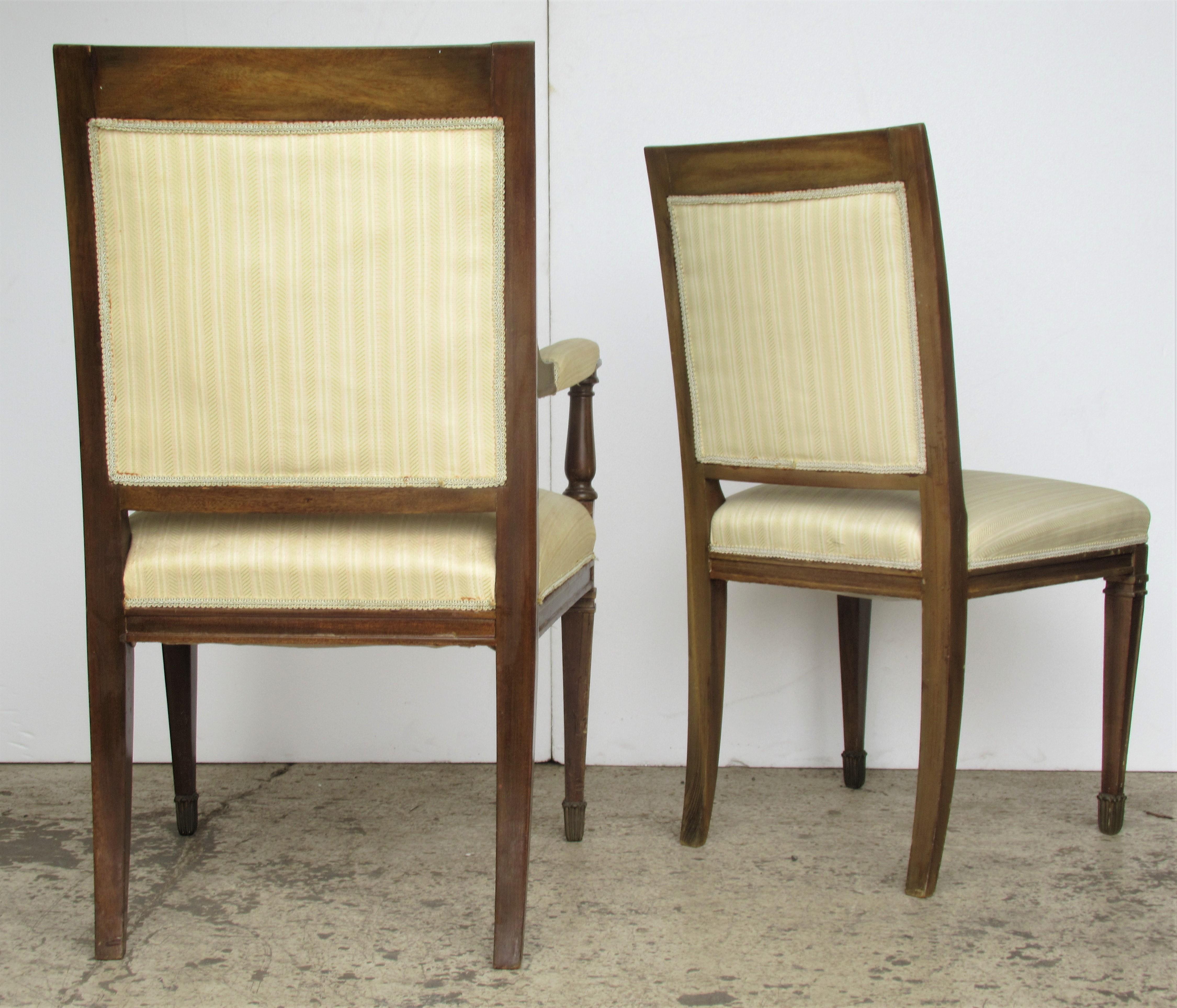 A matched set of ten French Empire style chairs with finely detailed brass metal  ormolu mounts at backs, legs and feet - the wood frames with aged original old finish . There are two armchairs and eight side chairs. Side chairs measure 36