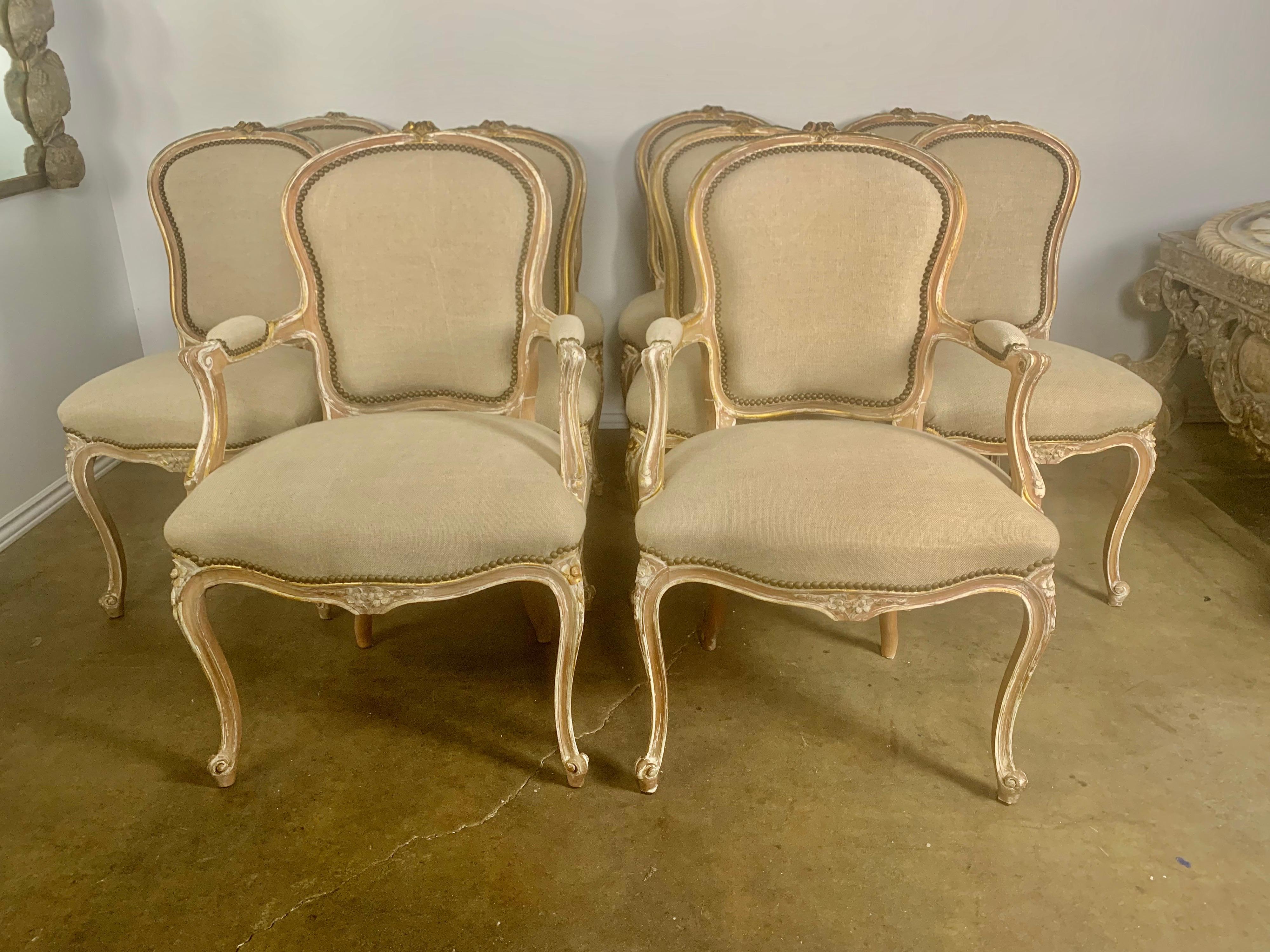 Set of ten 19th century painted Louis XV style dining chairs, two armchairs and eight side chairs, The ten chairs are beautifully hand painted and stand on four cabriole legs. The chairs are newly upholstered in a washed Belgium linen and detailed