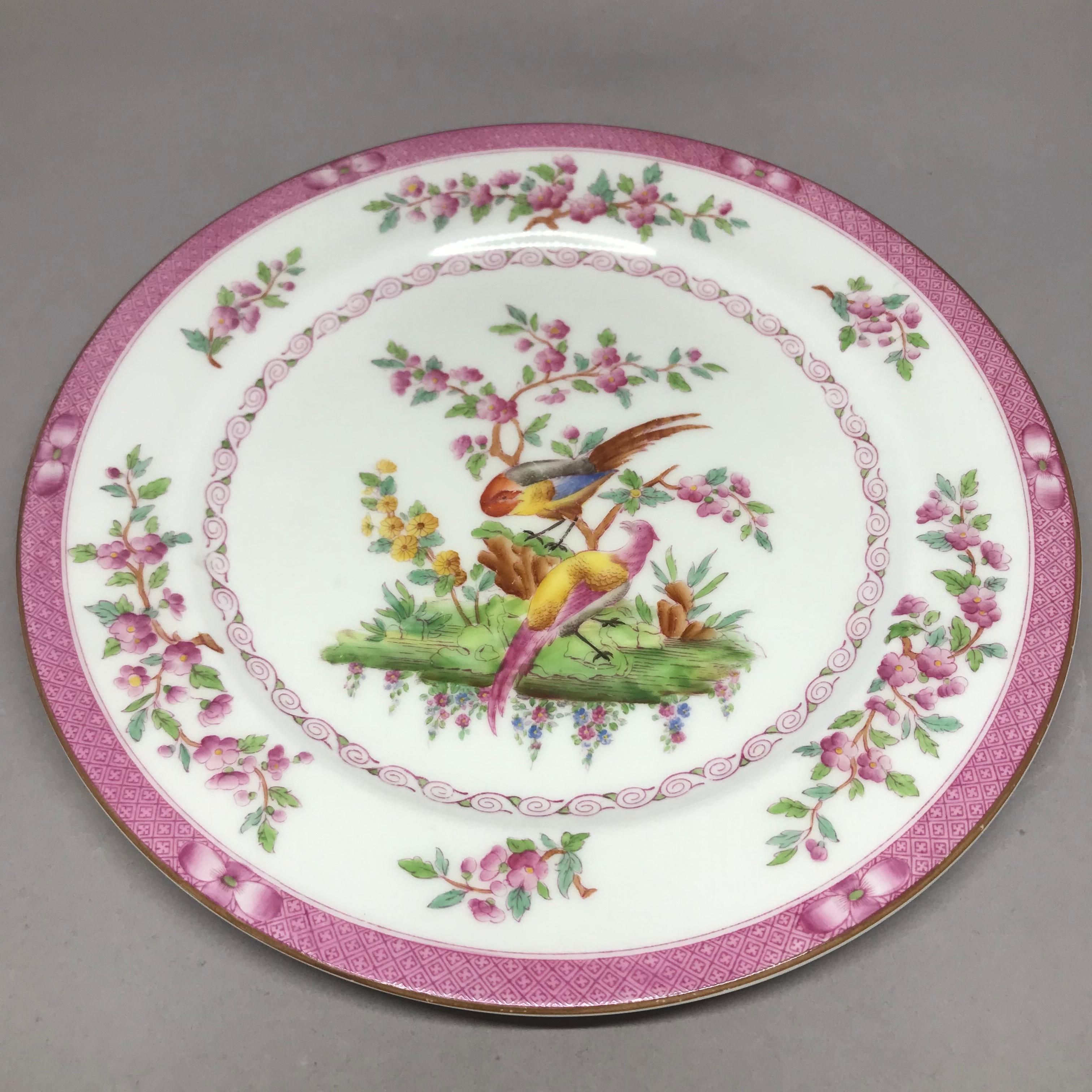 Set of ten pink bird plates. Ten pink rimmed and floral banded chinoiserie style dinner plates centering on a pair of exotic colored pheasants in a landscape. Markings for Royal Worcester England retailed by Bailey Banks & Biddle of Philadelphia.